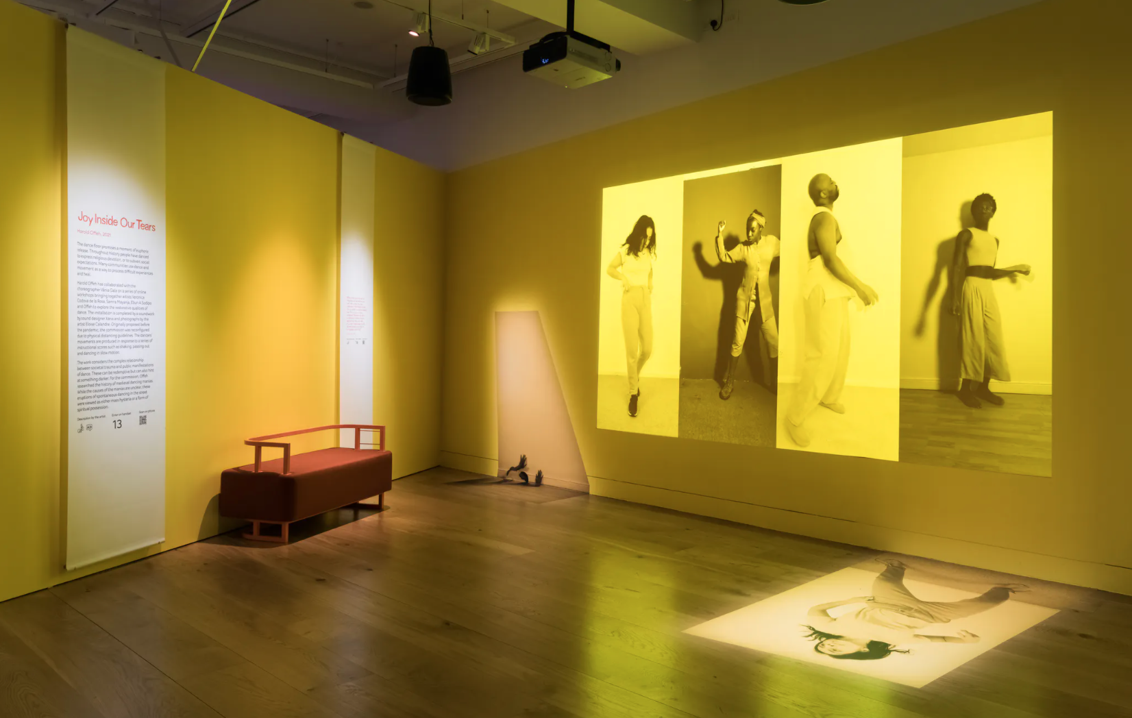 Exhibition space with yellow projection on walls
