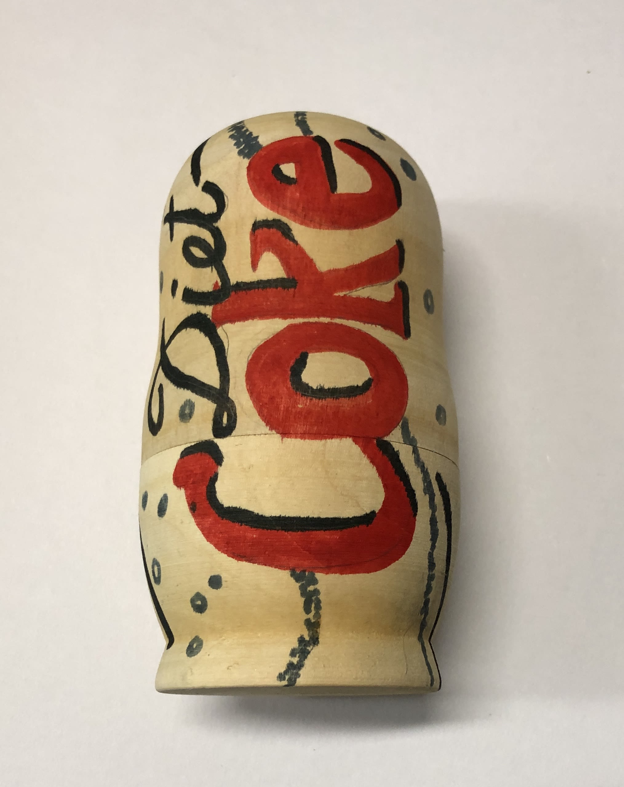 a wooden block painted to look like a diet coke can