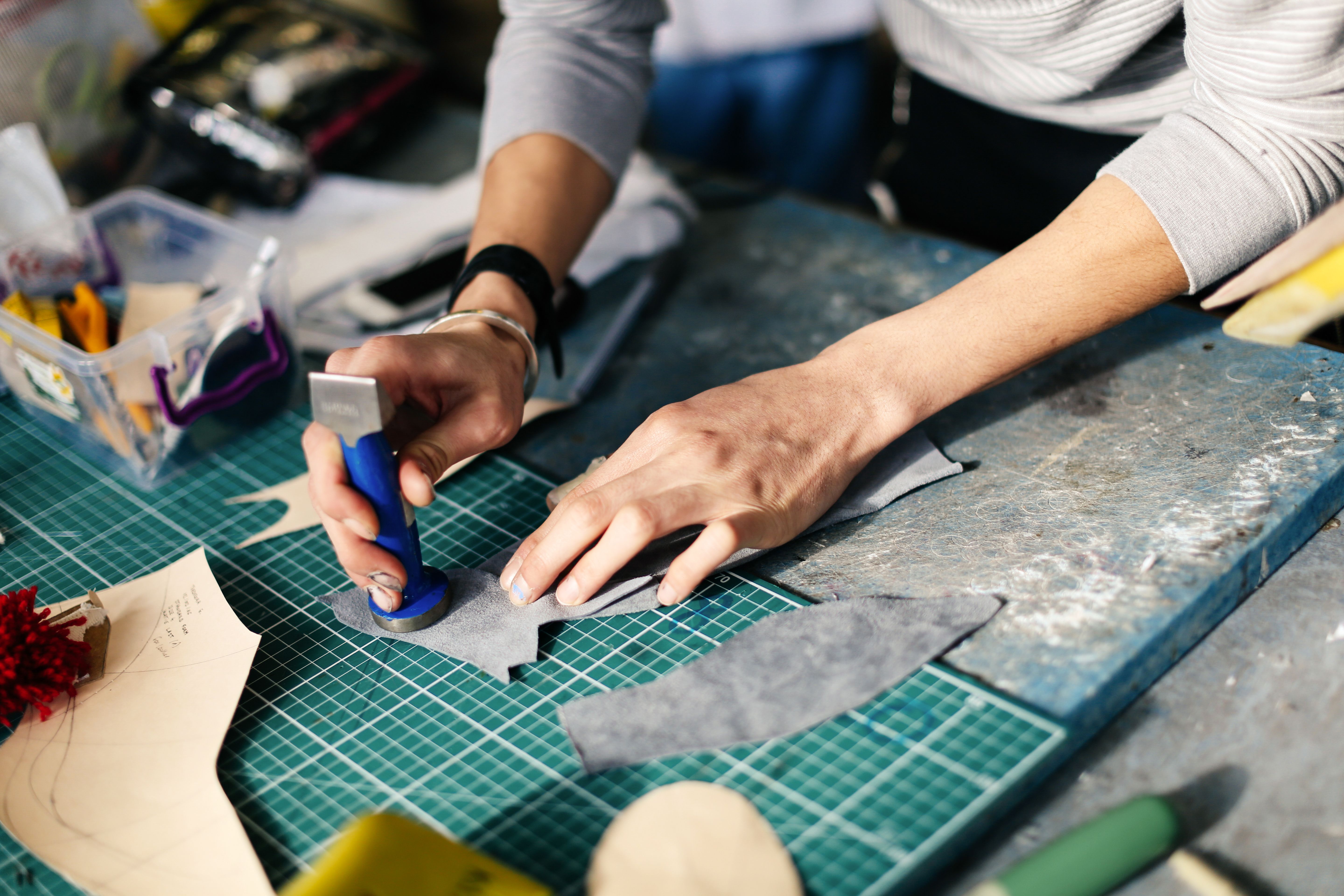 Student cutting out shapes on a cutting mat at London College of Fashion