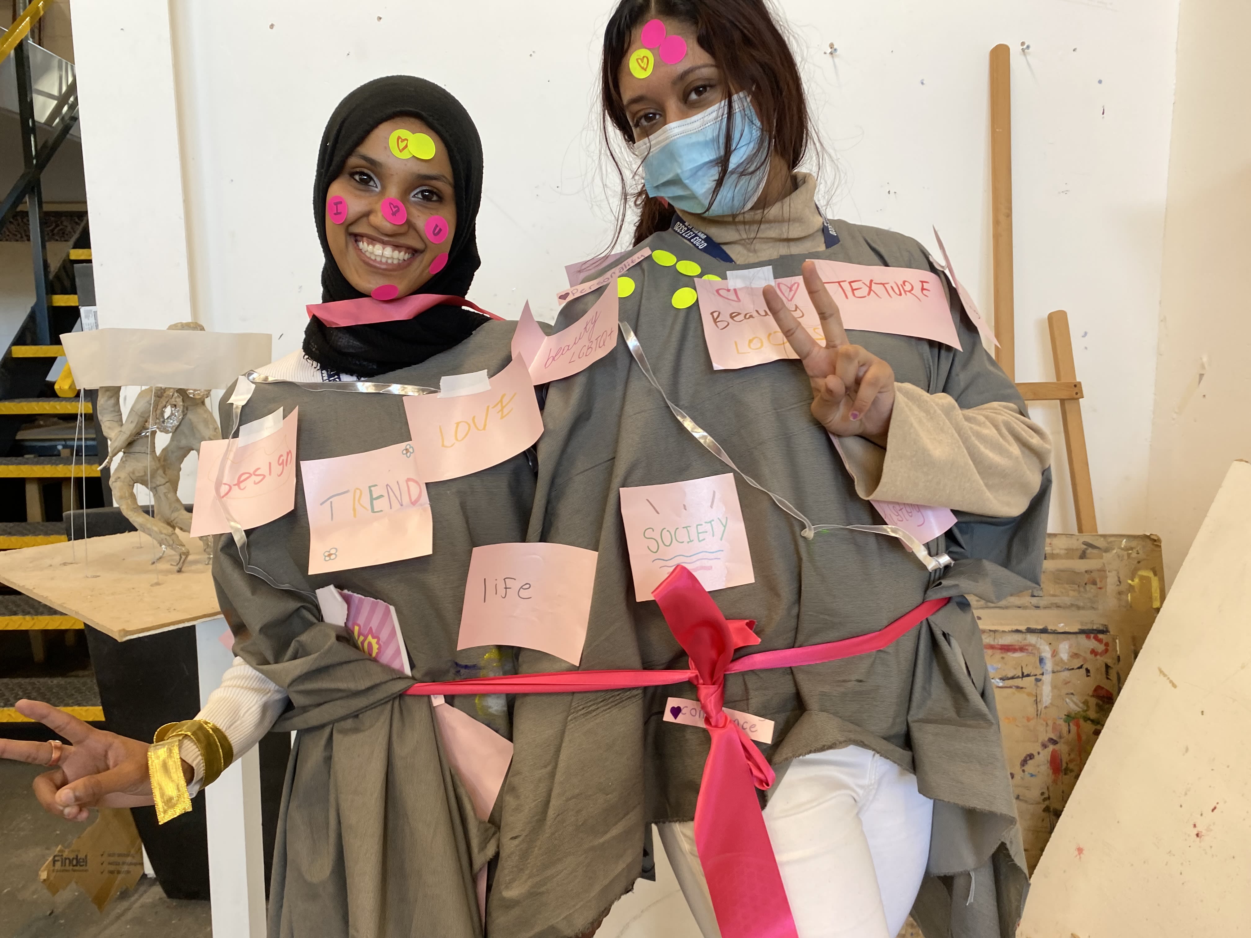 Two students with postit notes on their bodies