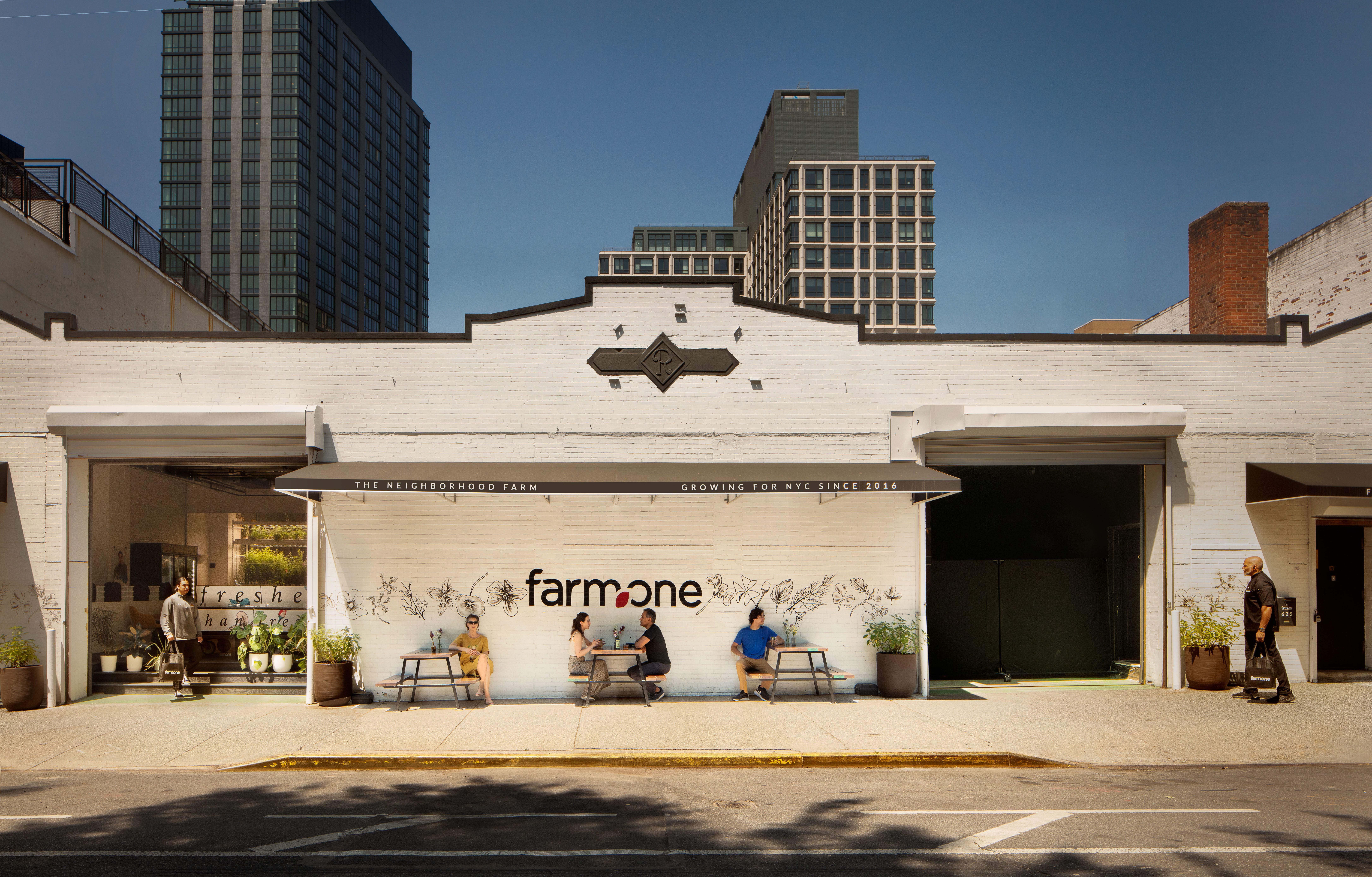 People sitting outside the Farm.One building