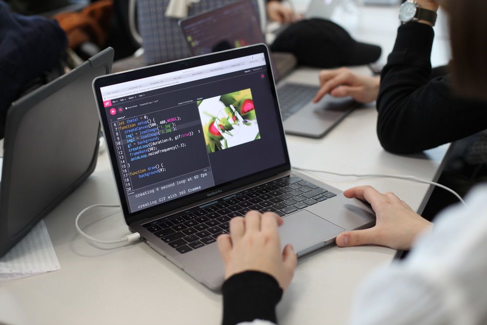 Image of person working at laptop on table