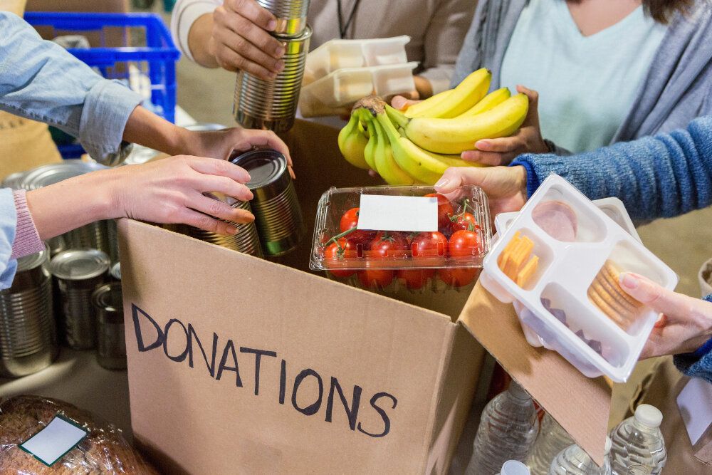 people giving donations to a food bank