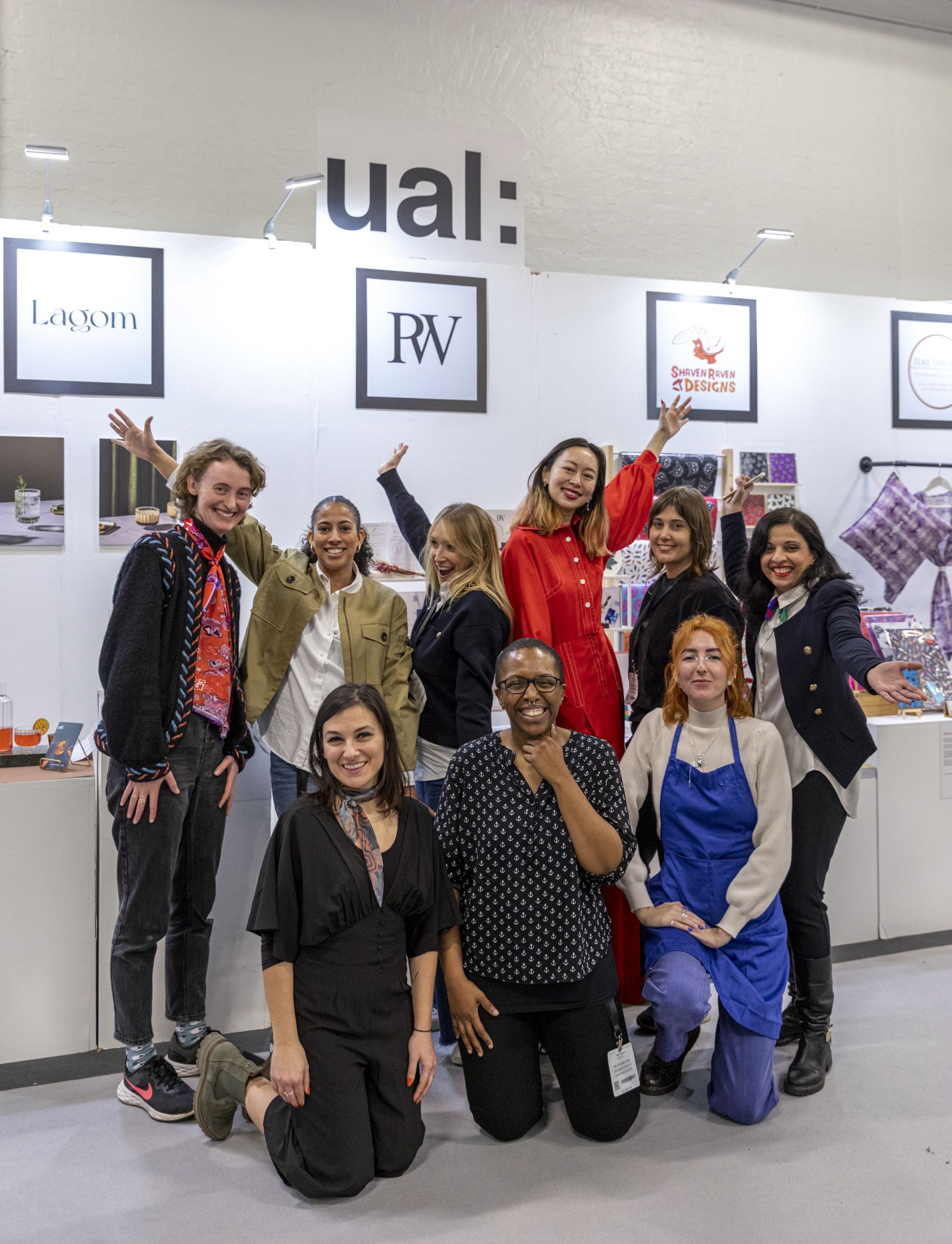 All the designers from Top Drawer pose together in front of the UAL stand