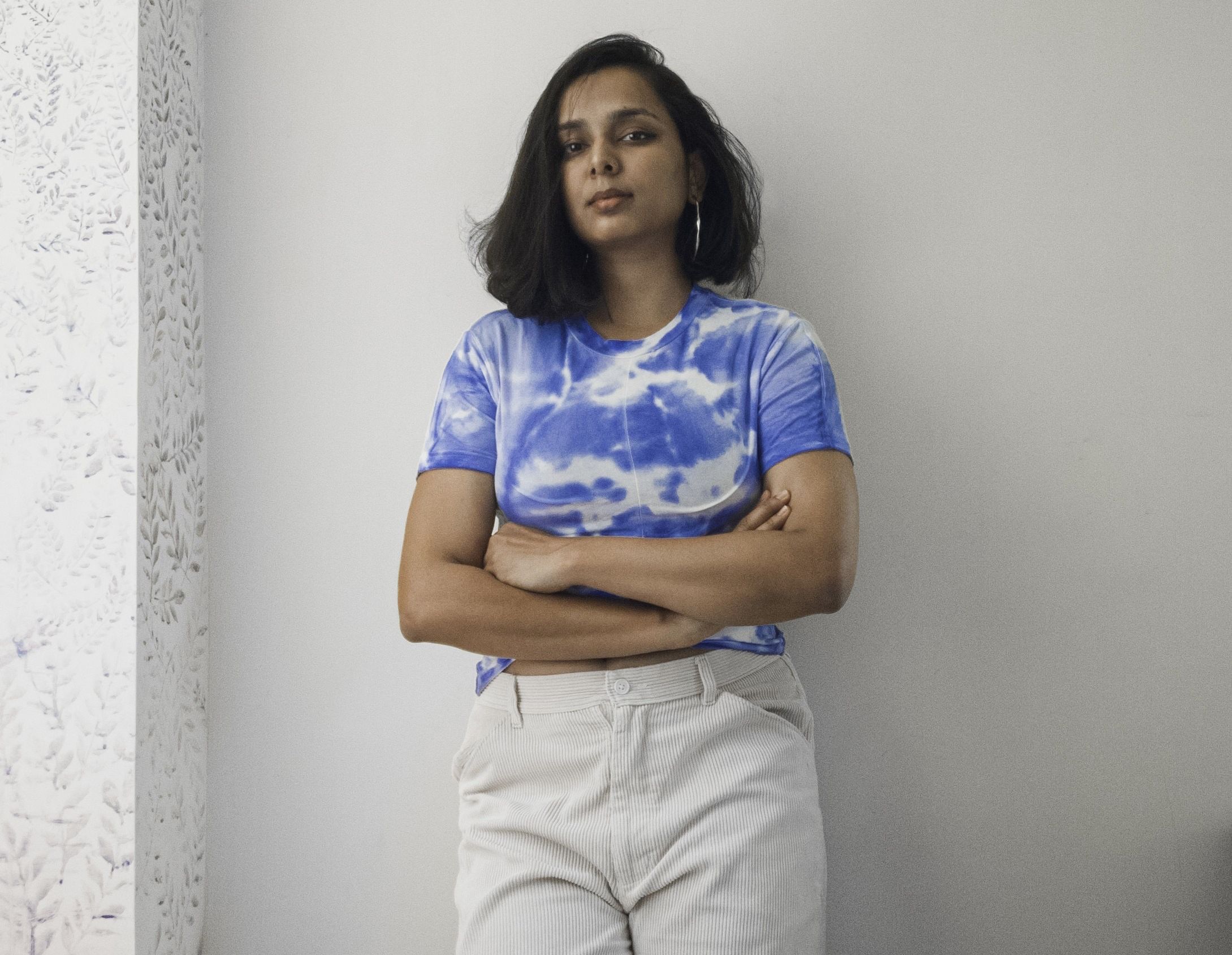 Portrait of a Indian woman in a blue top and white pants
