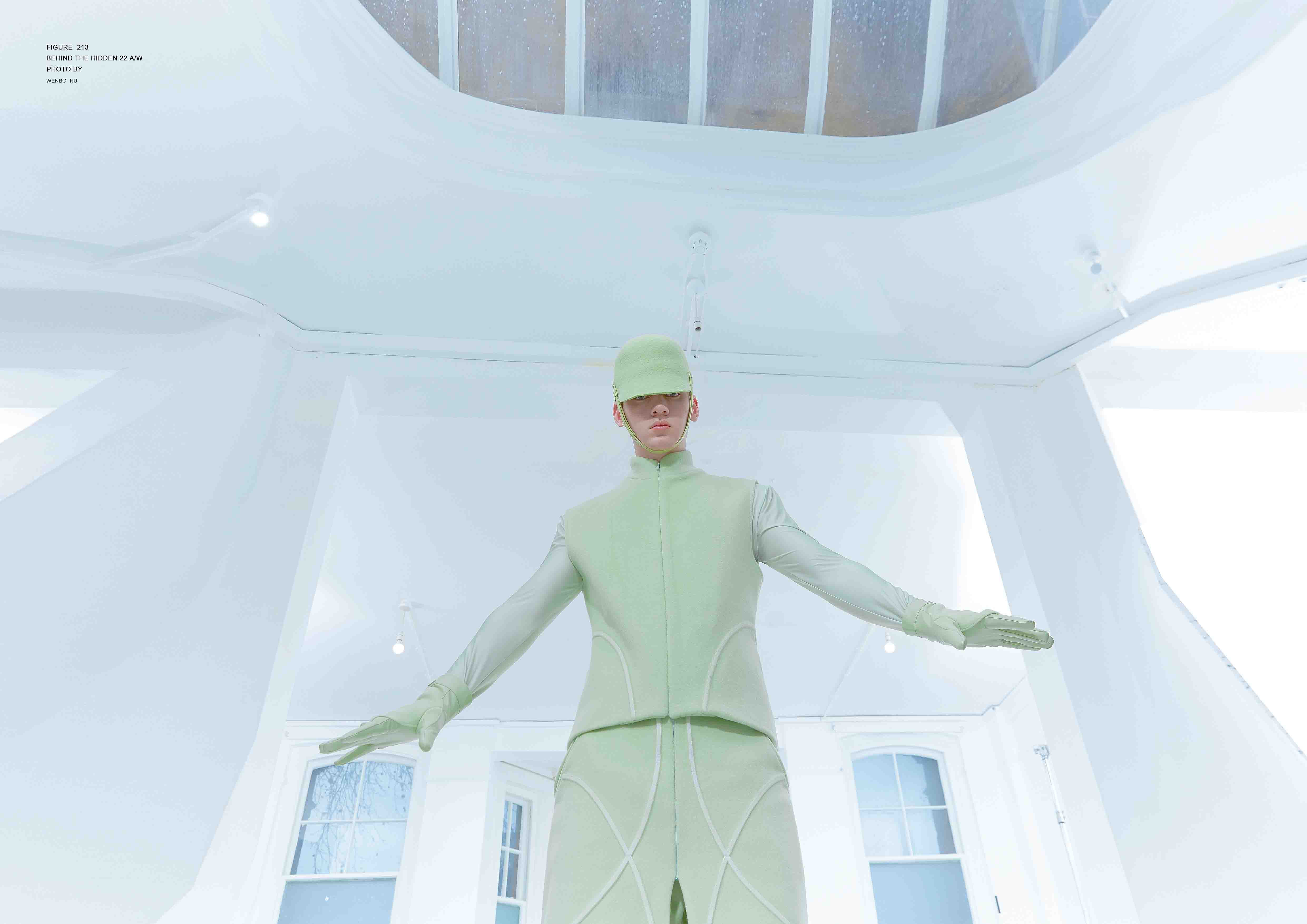 Model in green garments with arms spread