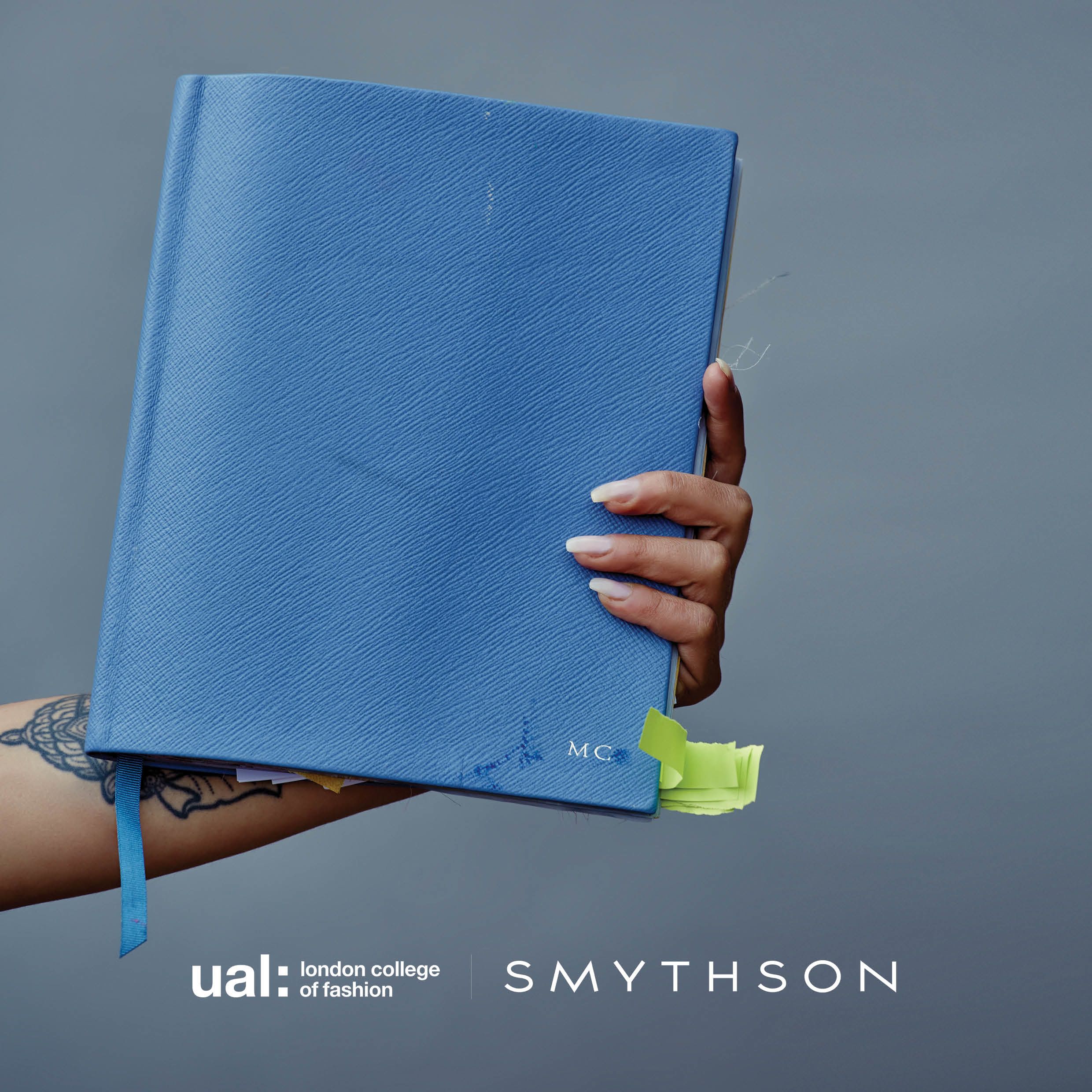 Person holding blue notebook
