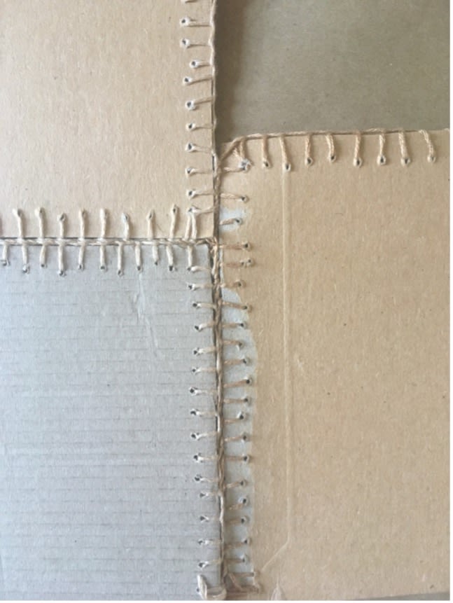 Stitched and quilted cardboard workwear for artists. Detail of work in progress. Cardboard packaging, leftover wool. Sara Grisewood. January 2022