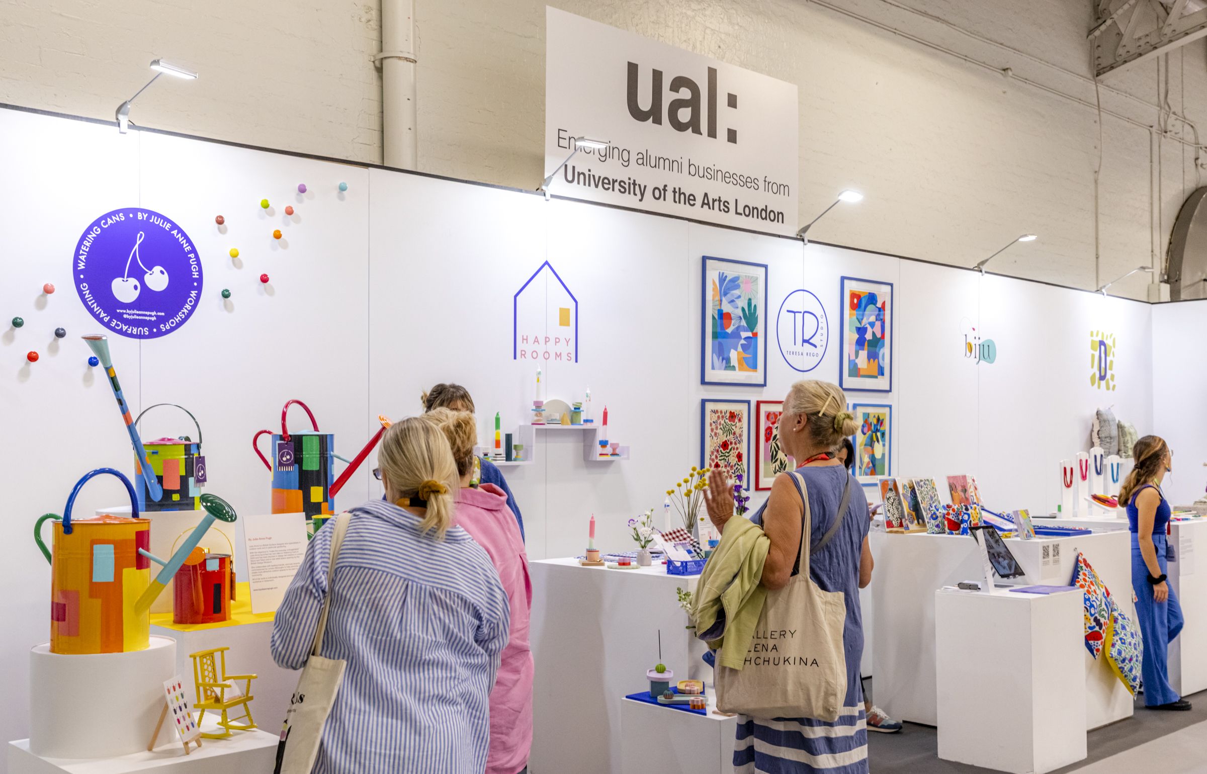 The UAL stand at Top Drawer, people are standing in the foreground looking at colourful products on display.