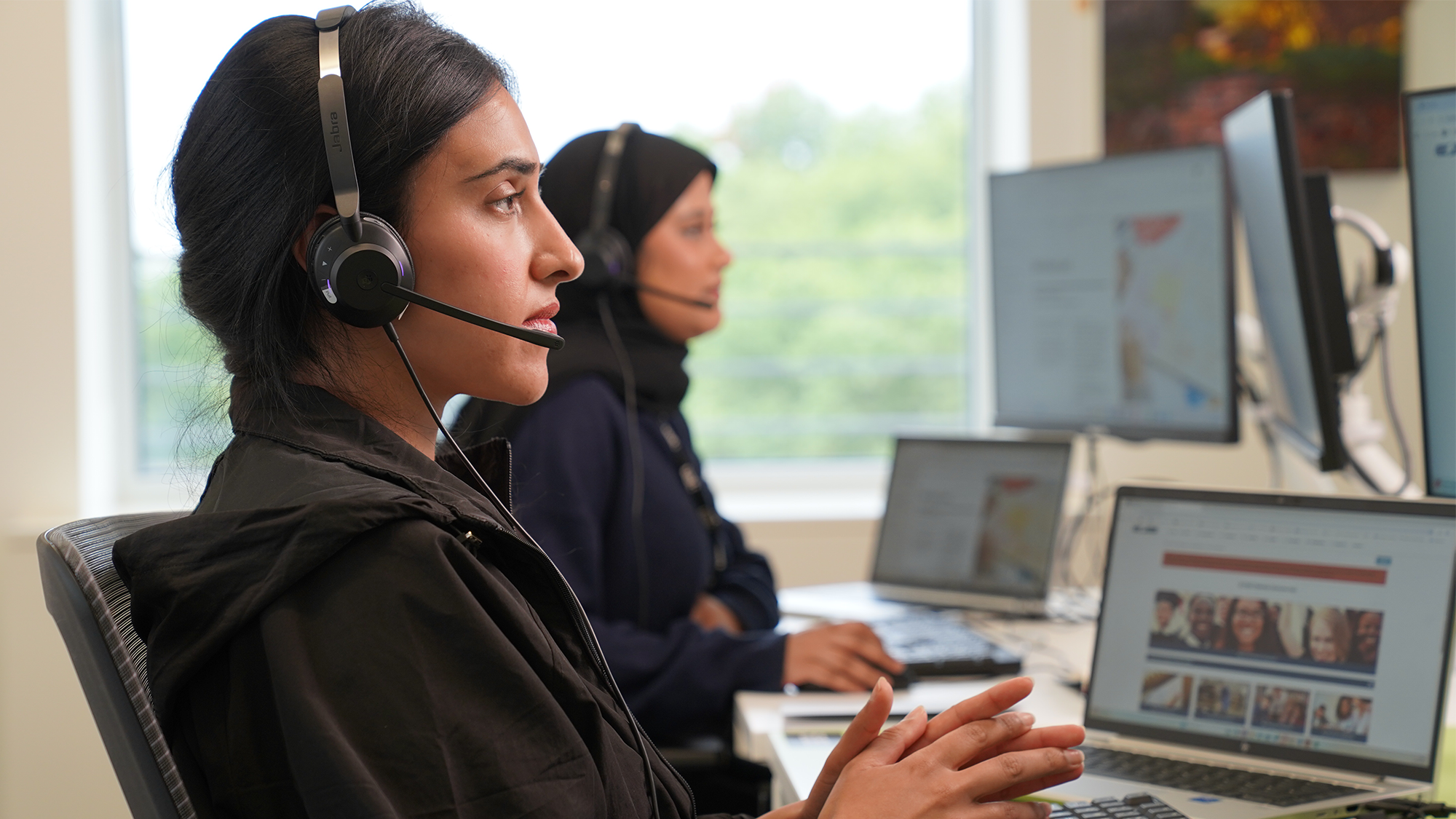 woman at work with head set on in an office setting