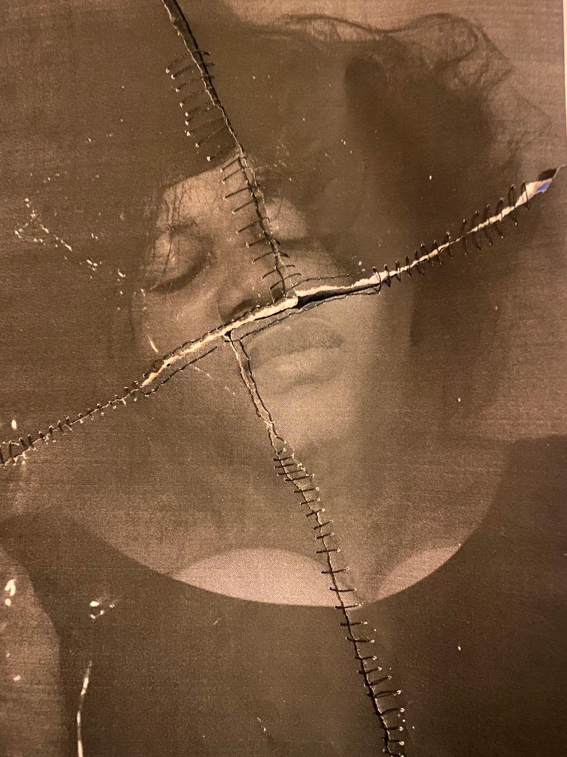 an image of a woman torn apart and sewed back together