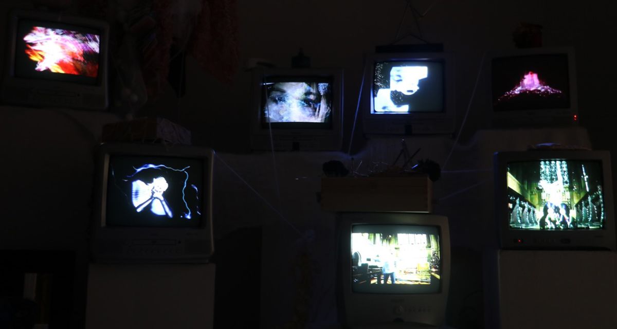 Still from a sound arts film featuring speakers and televisions.