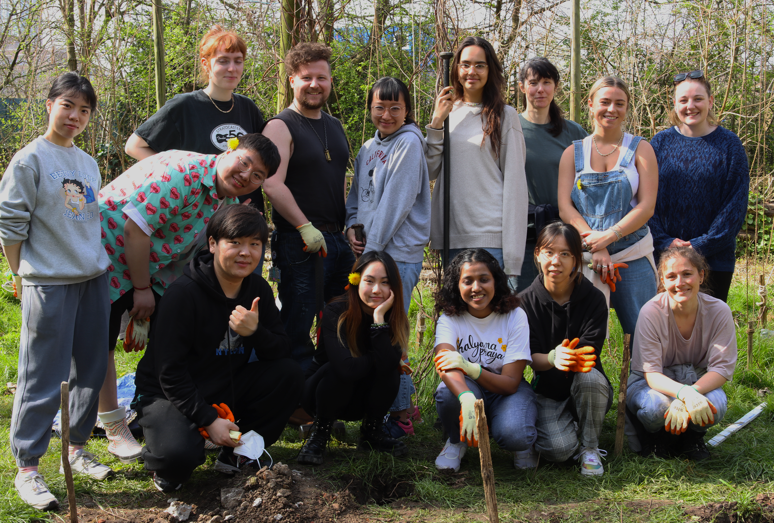 A group of UAL staff and students pose at Stave Hill Ecological Park in London