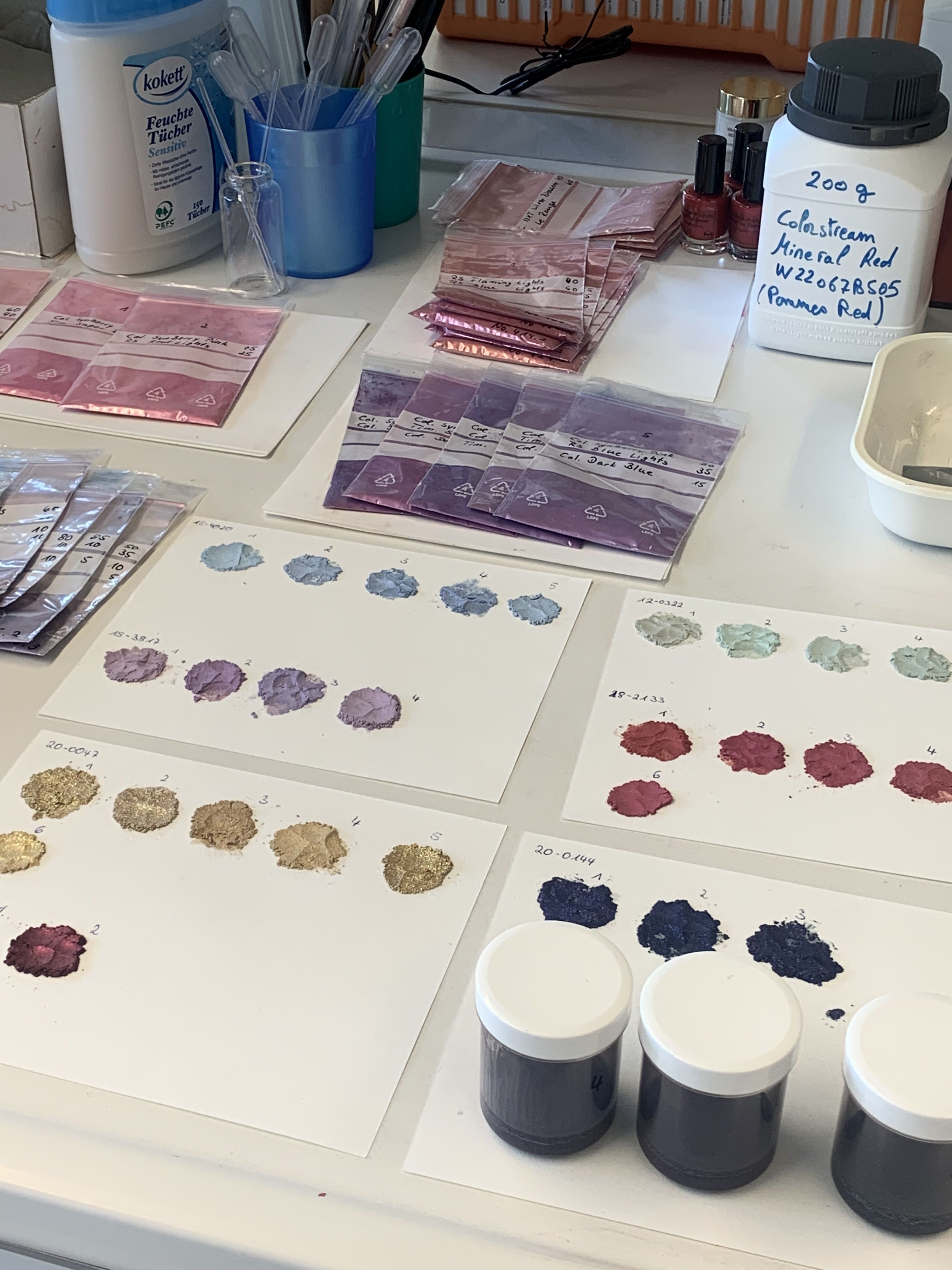 Varying shades of eye shadows laid in colour palettes for lab sensory testing