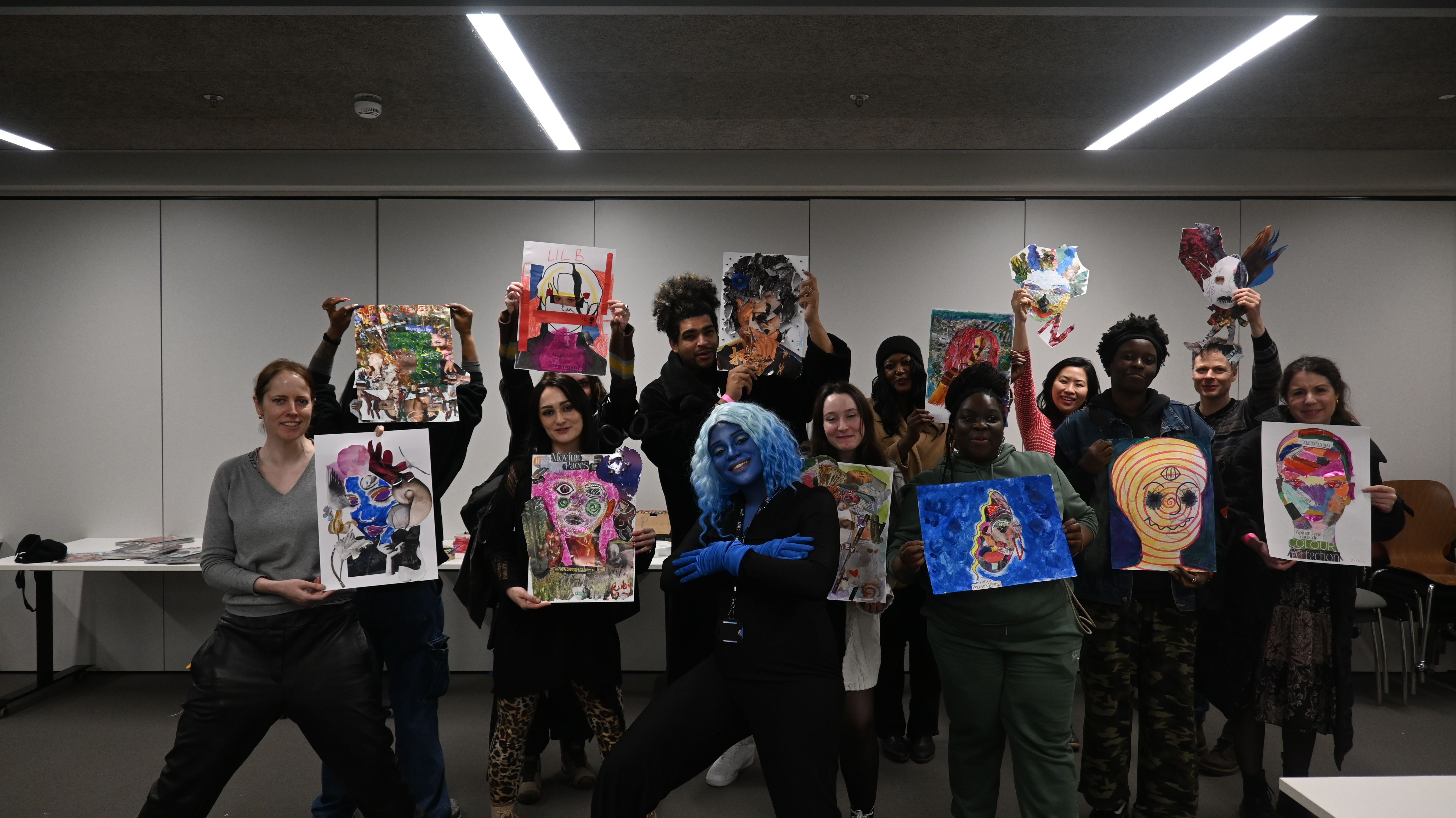 Group of people posing with posters in their hands.