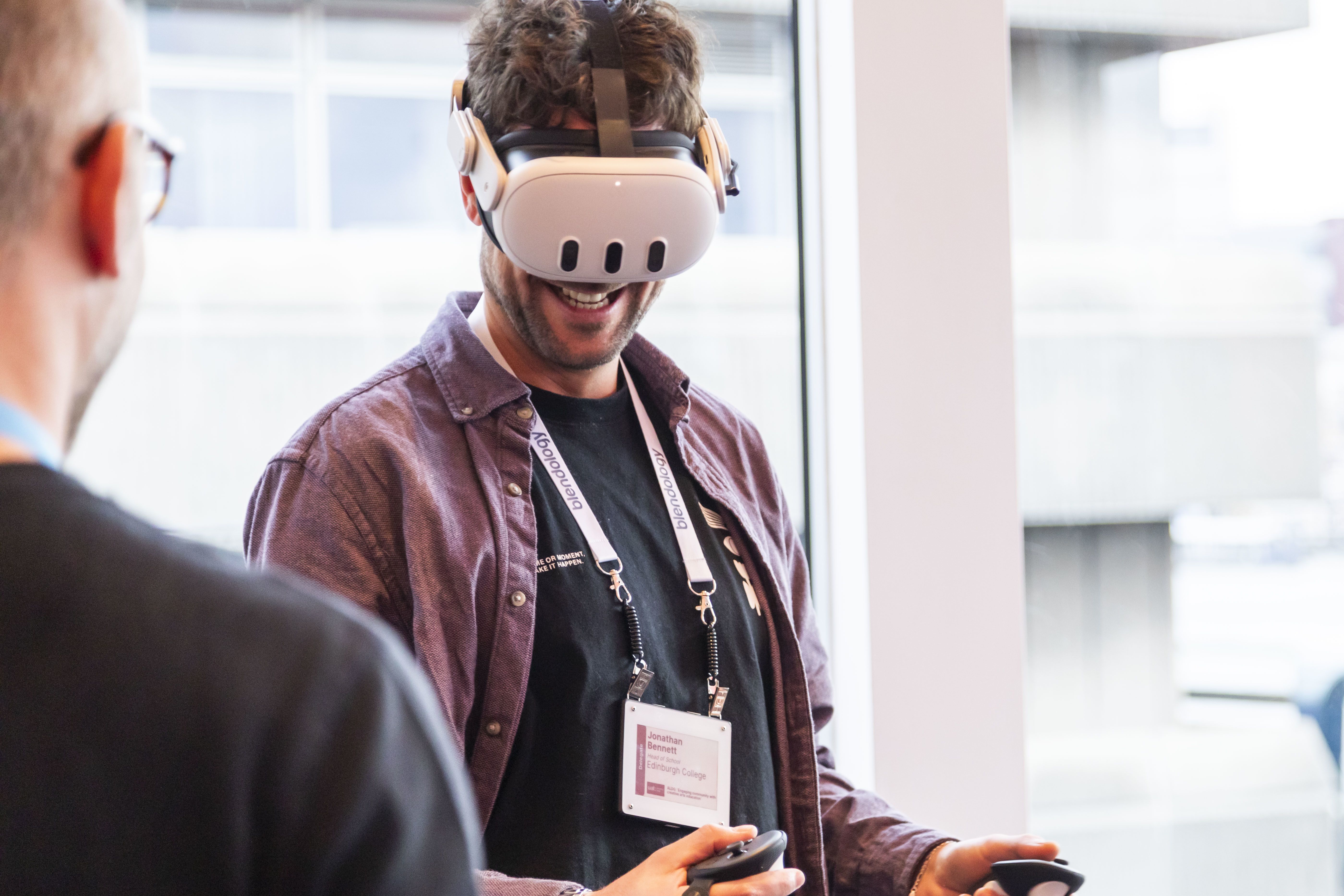 A guest at UAL Awarding Body's Teach Inspire Create Conference 2024 using a VR headset