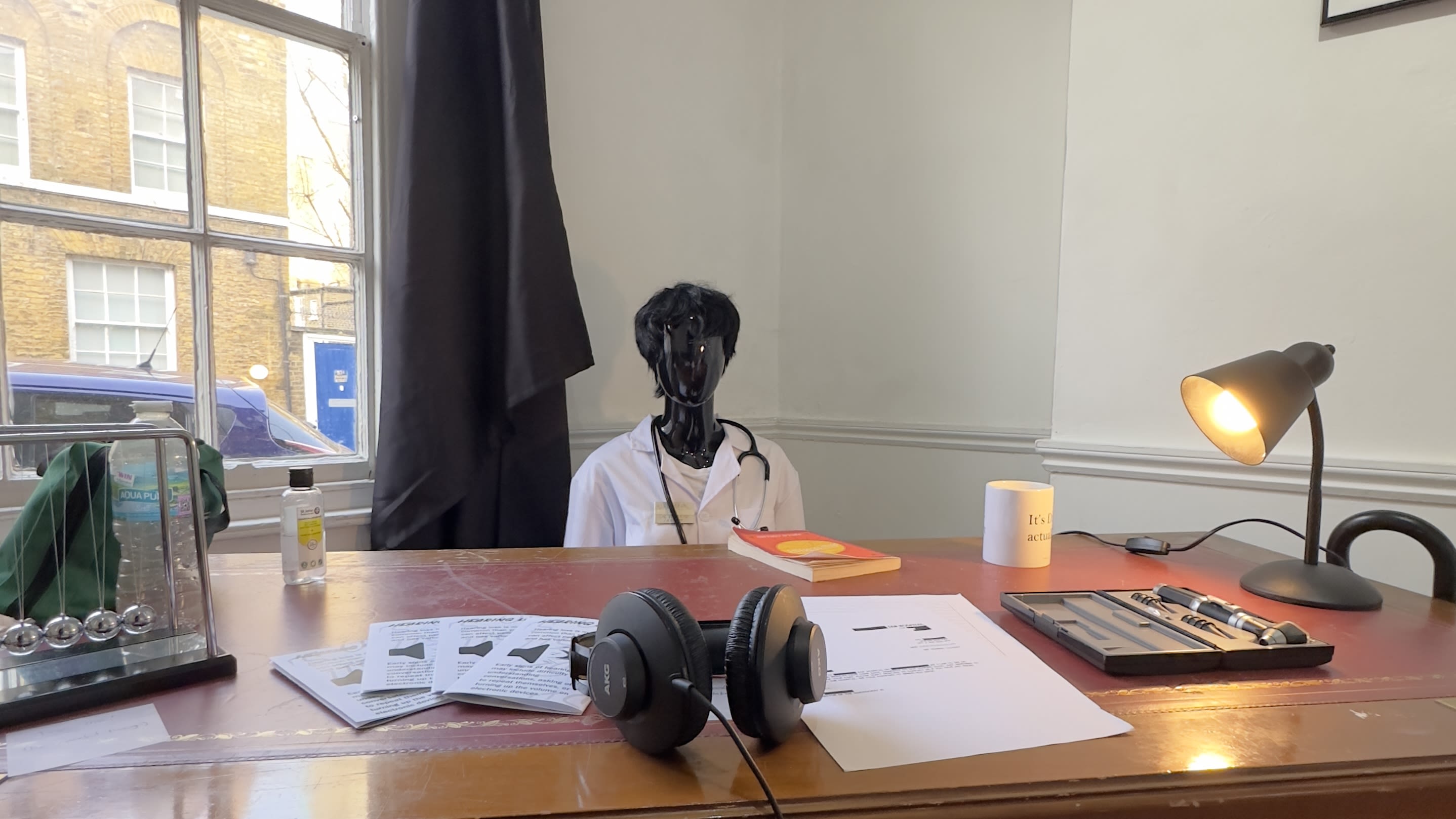 Model of a doctor sitting at a desk