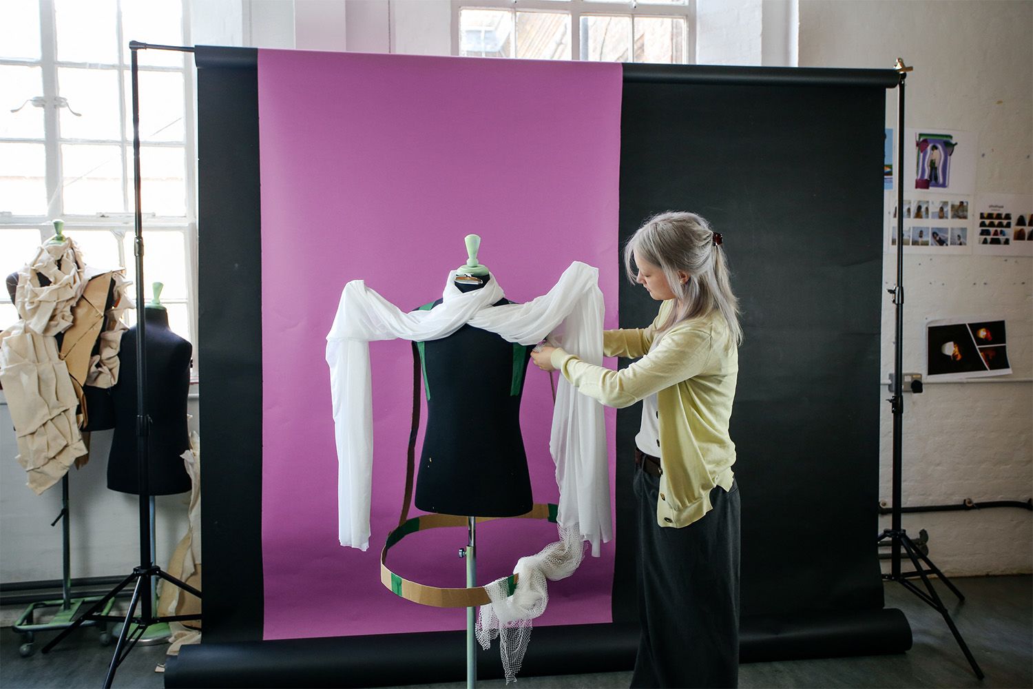 Image of someone draping fabric over a mannqeuin