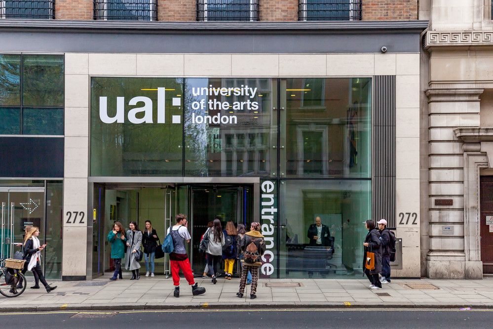 Roadside entrance to UAL's High Holborn office building. A number of individuals are stood by the door.