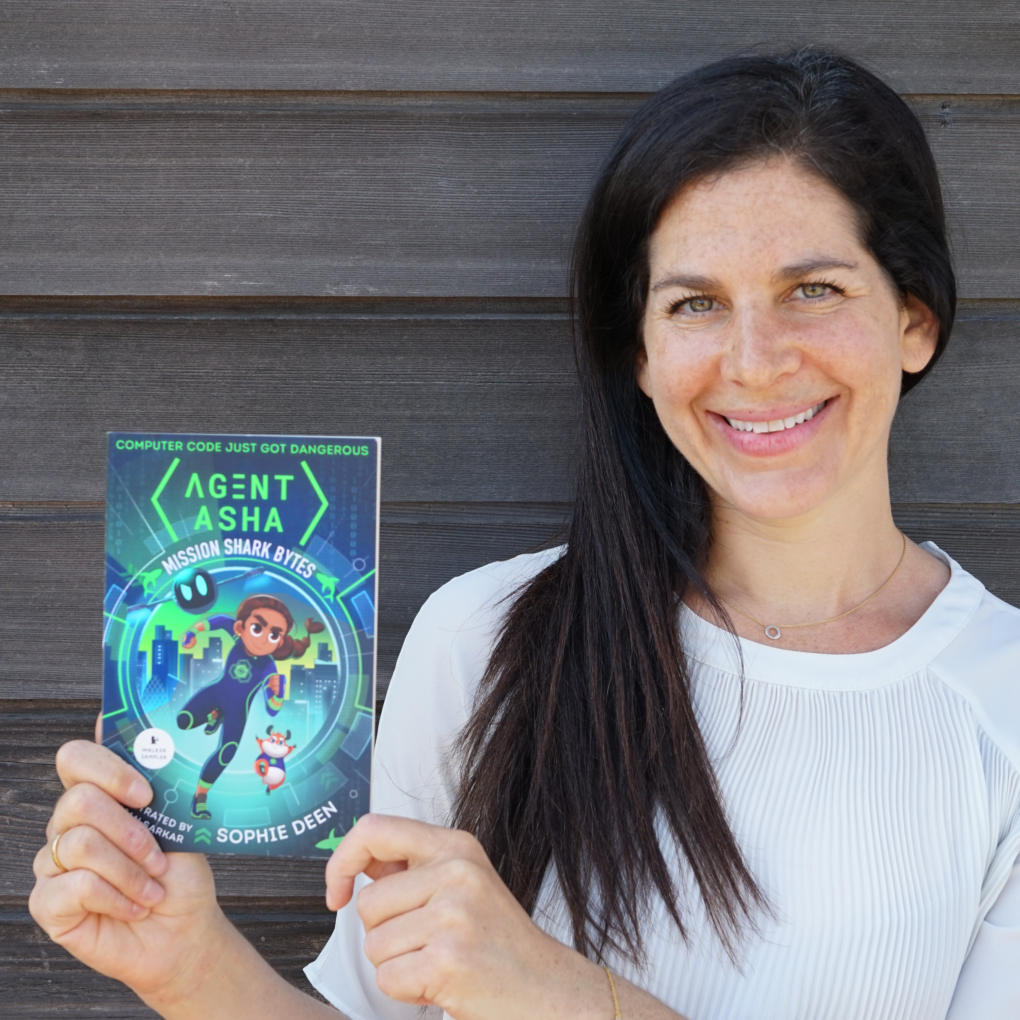 Headshot image of Sophie Deen holding her book