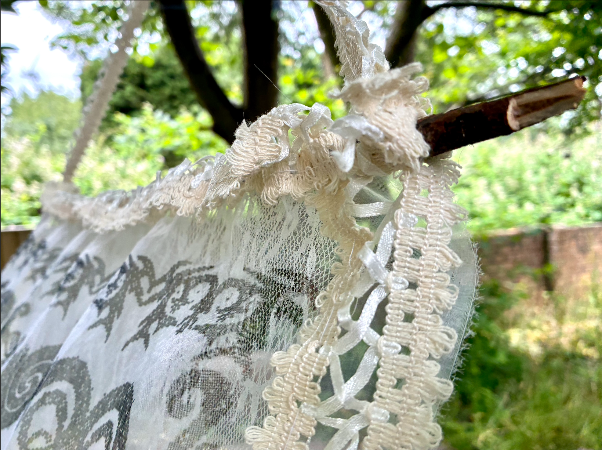 Mesh fabric hanging on wooden pole