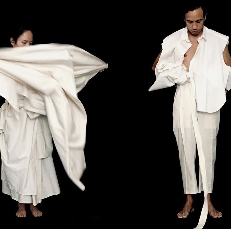 male and female in white robes in the process of dressing/undressing