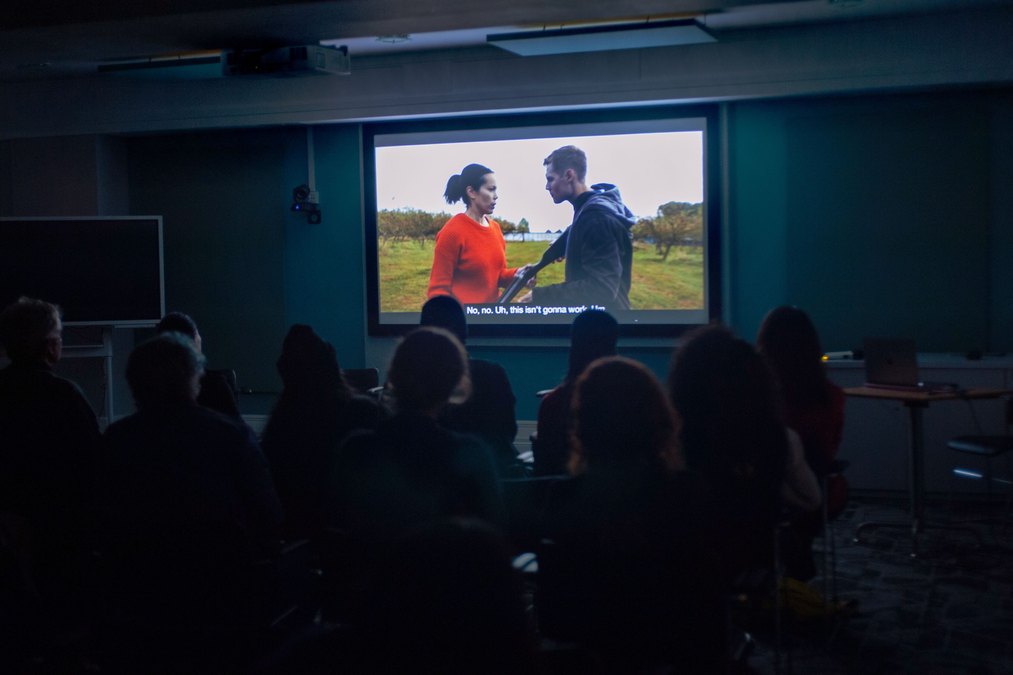 freeze frame from an alumni video played at the AoCA screening event