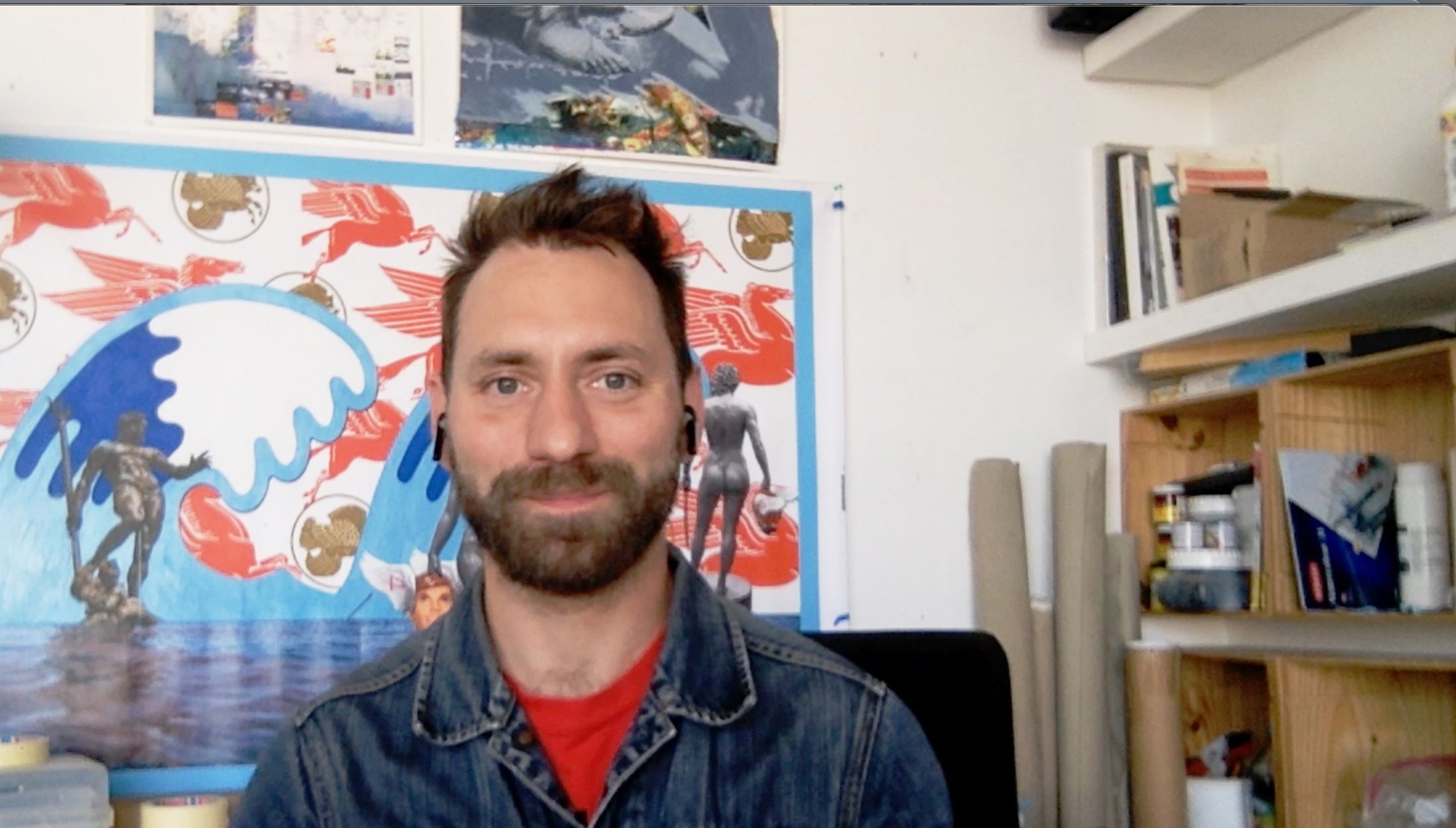 head shot of man with ear piece on zoom call