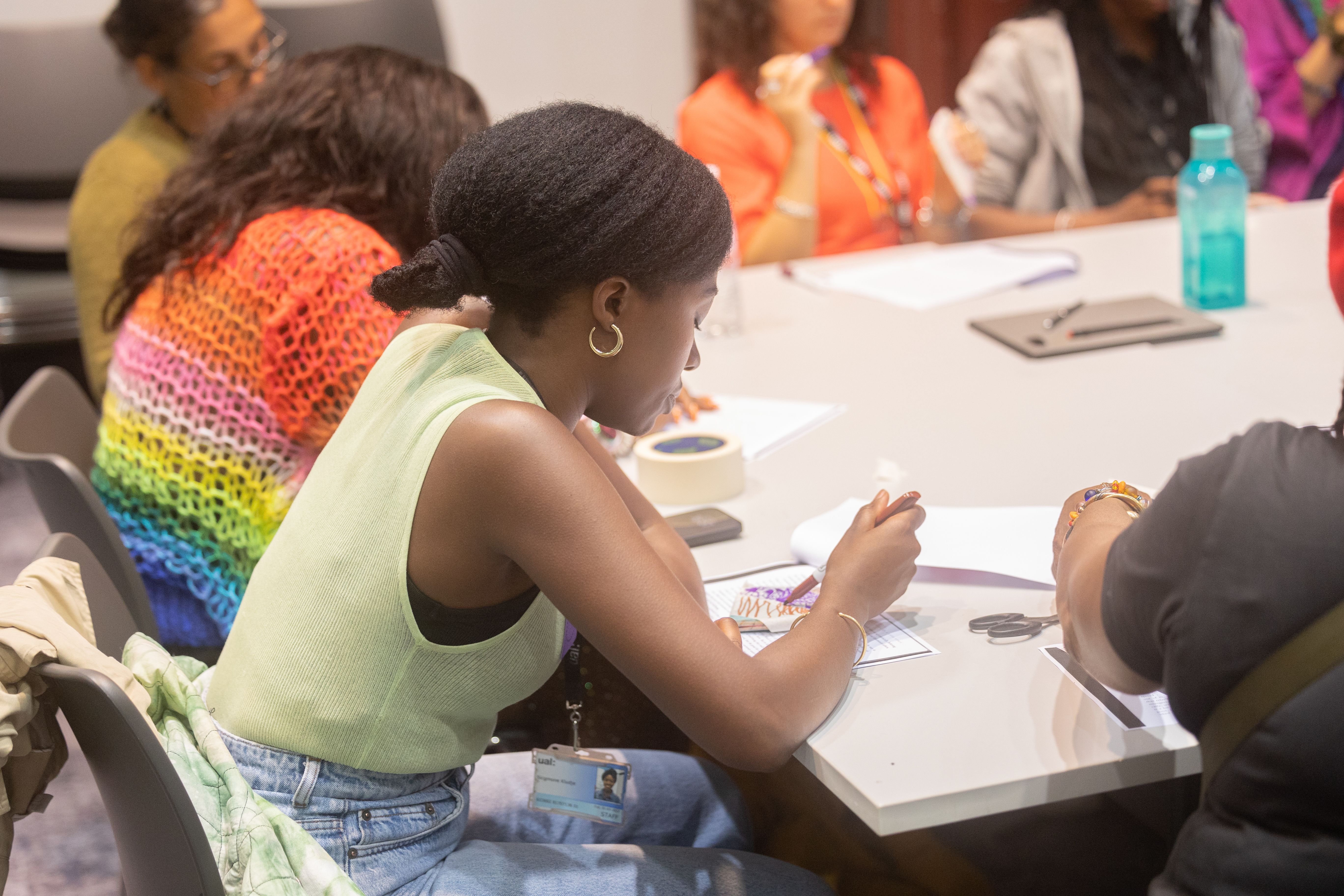 A group sit around a table at a reading group