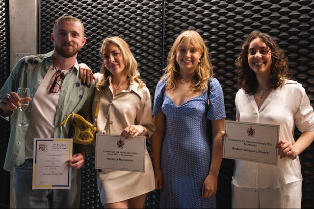 4 students standing holding certificates 3 females and 1 male.