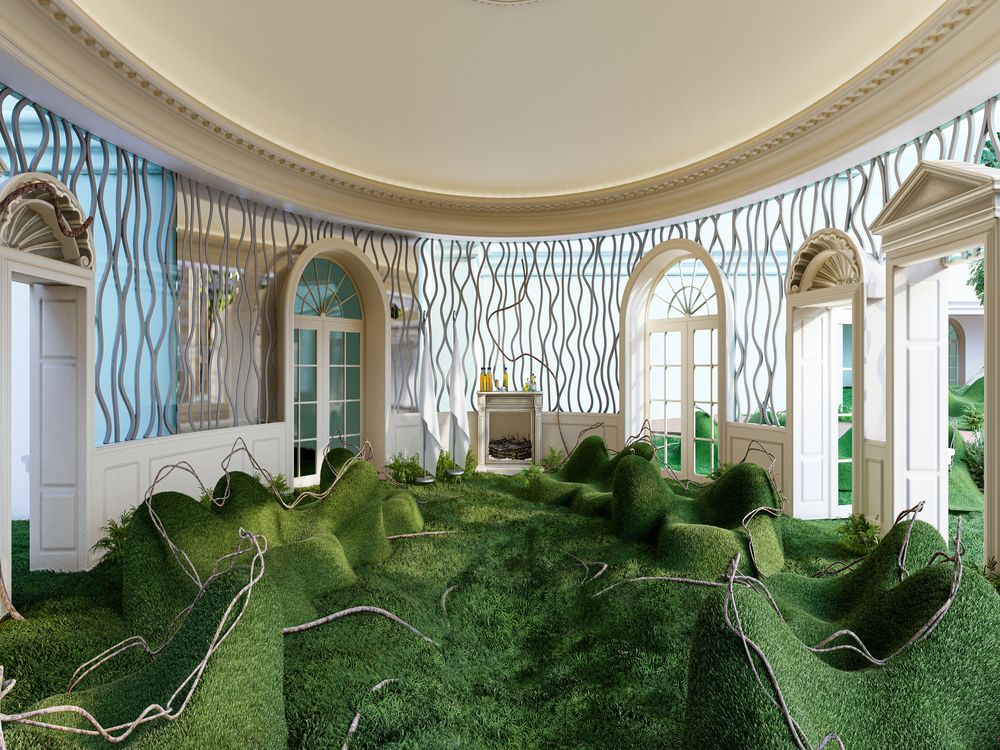 Mounds of grass in a room made of large windows looking out onto a forest 