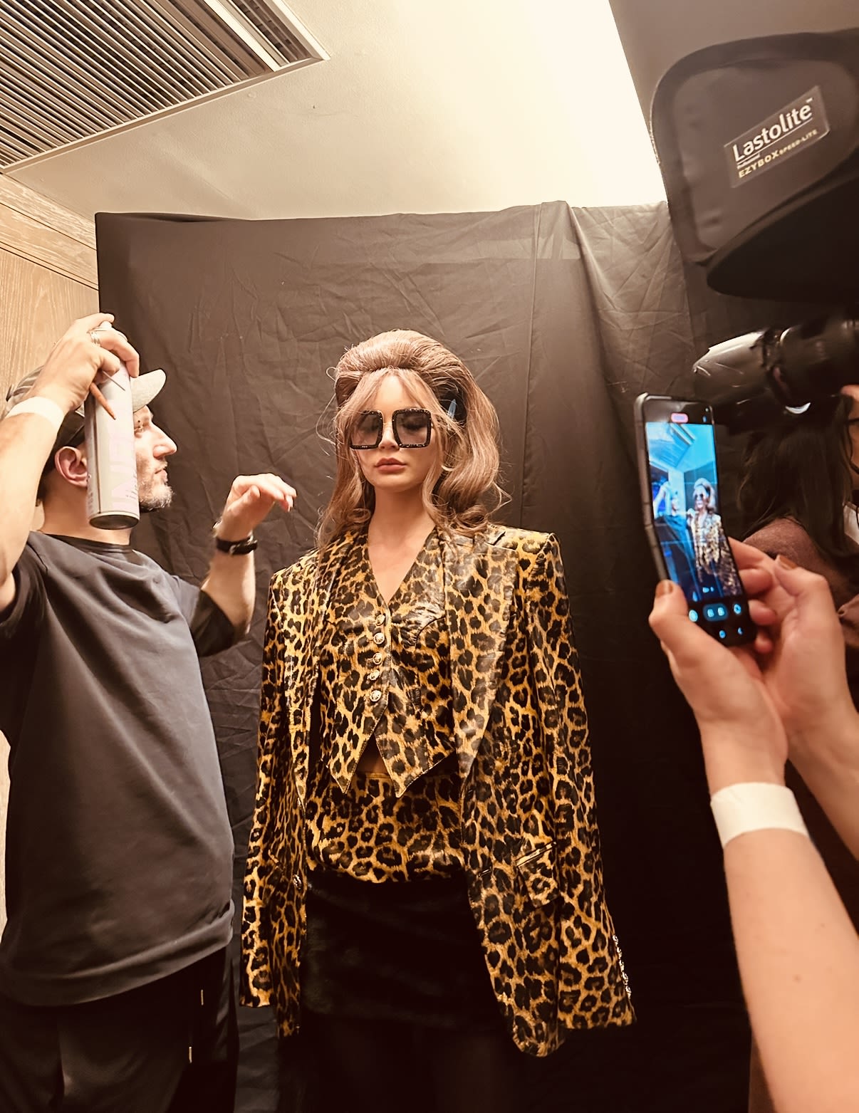 A fashion model getting ready by people