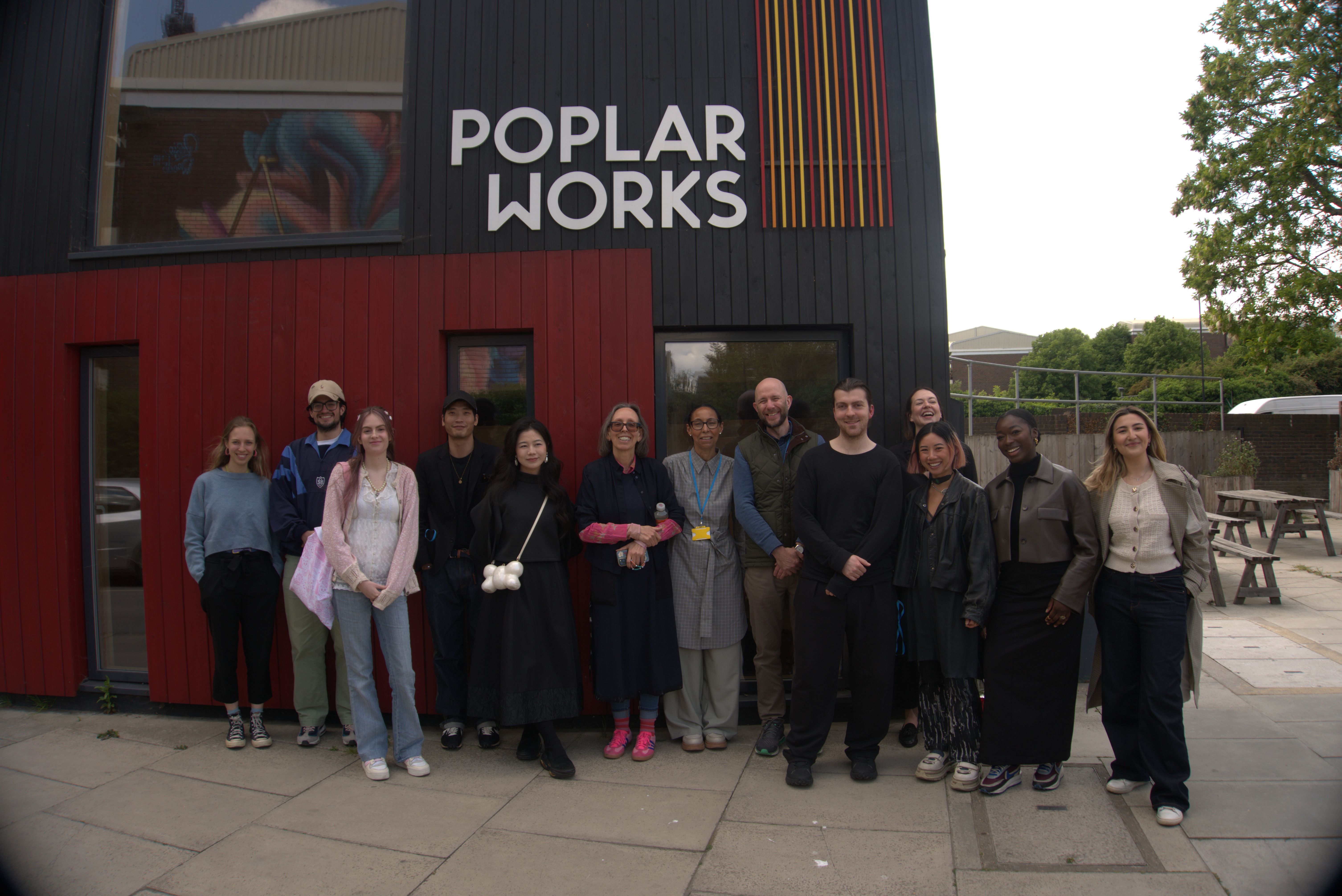 Group of people standing outside a building.