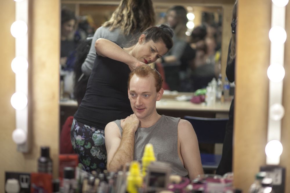 Person having hair done backstage