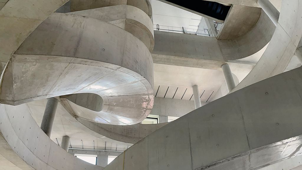 View of the insitu-concrete poured staircase, designed by Allies and Morrison and installed by Expanded. Photography by Allies and Morrison.
