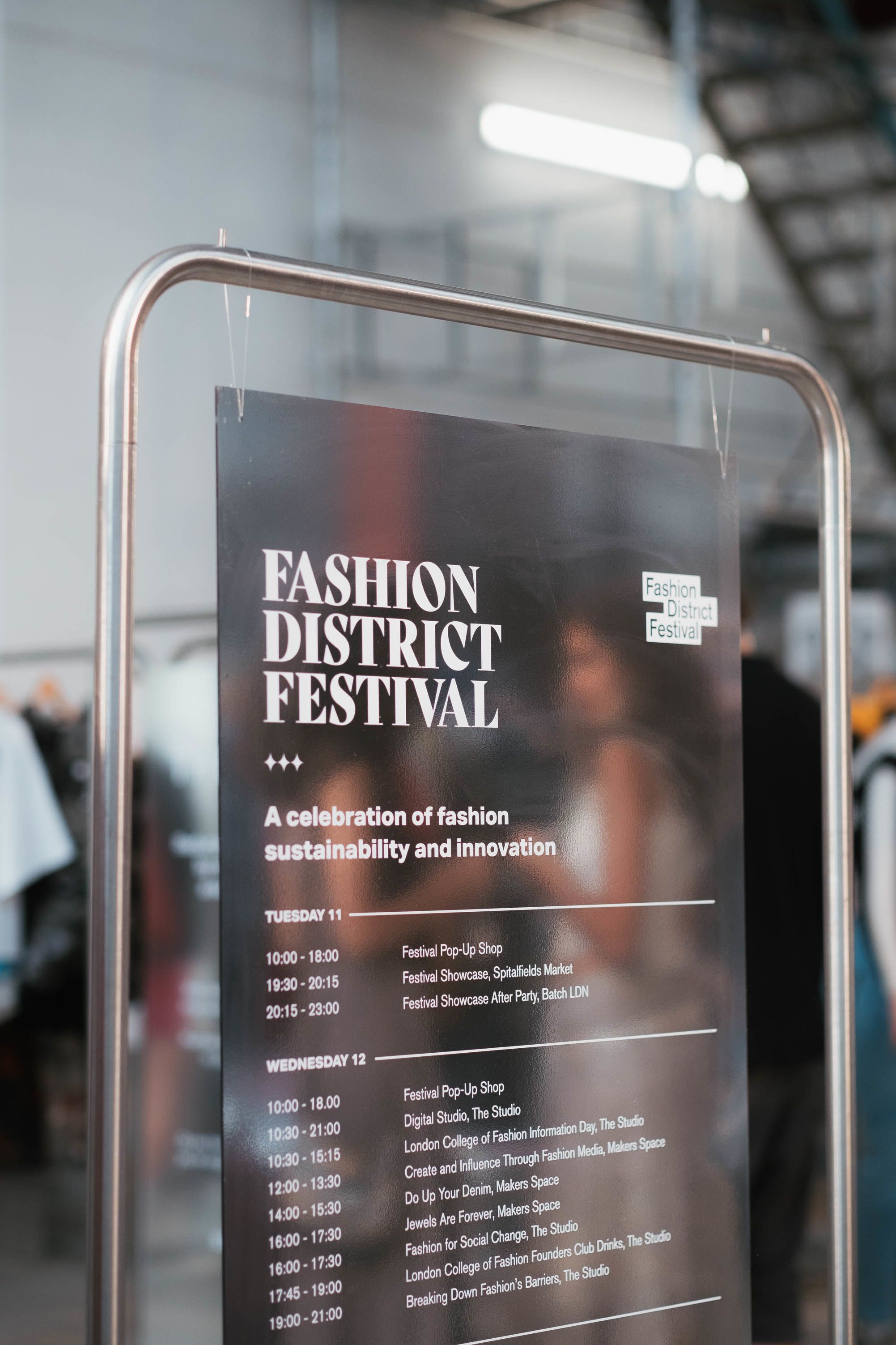 Card hanging on rail of clothes 