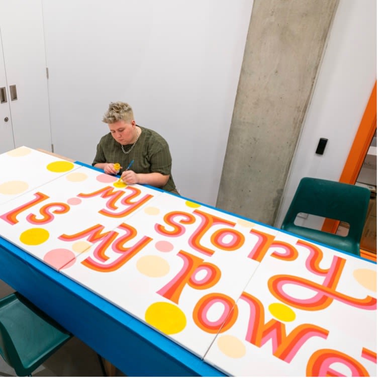 Abi Chapman creating community mural piece