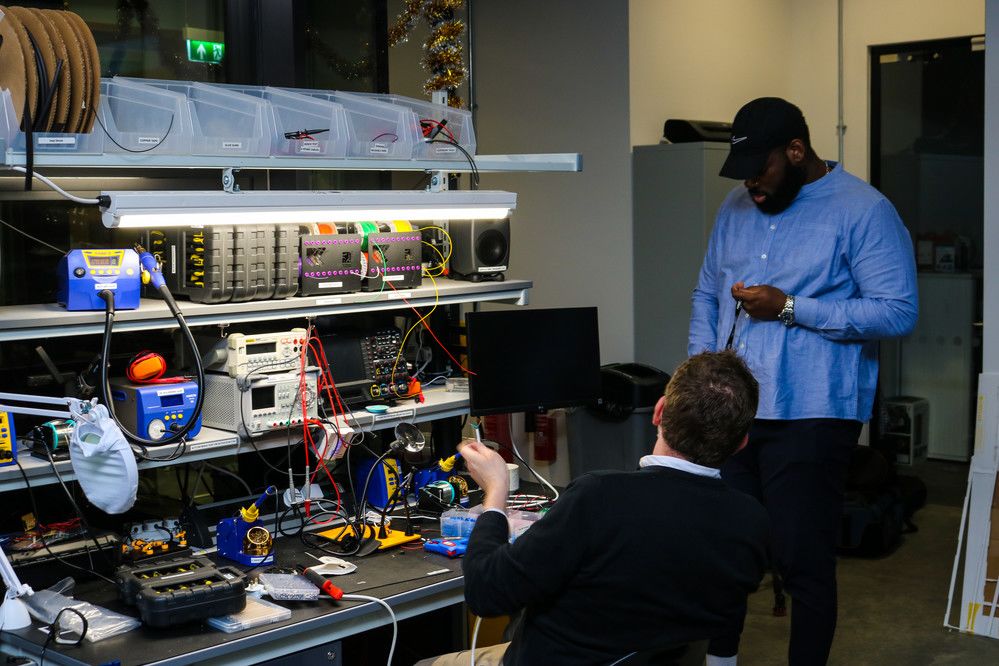 Two people stood near a range of electronic equipment