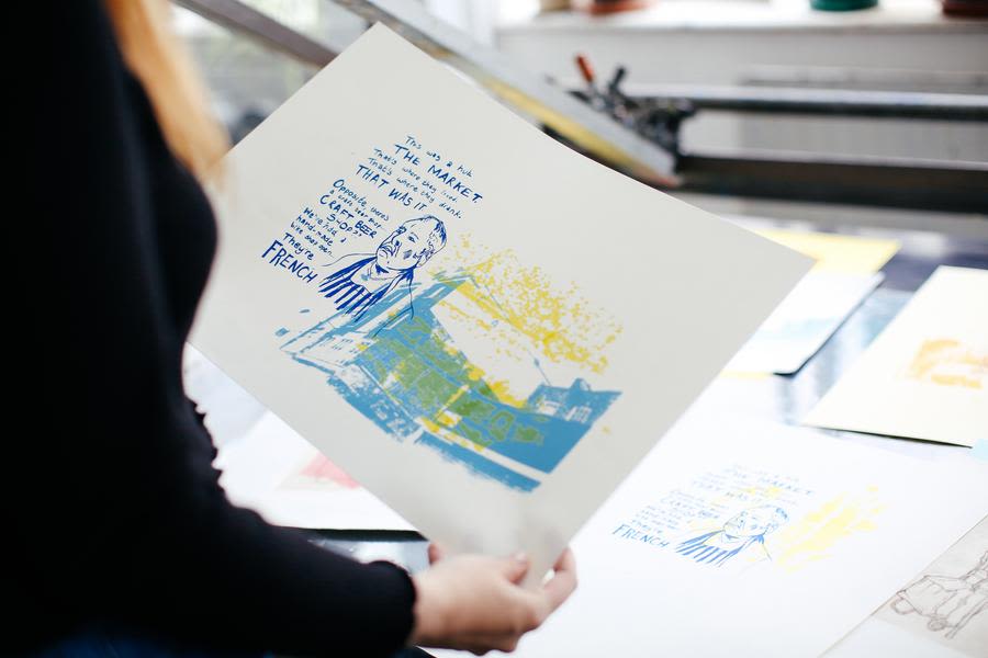 A person holding a graphic illustration.