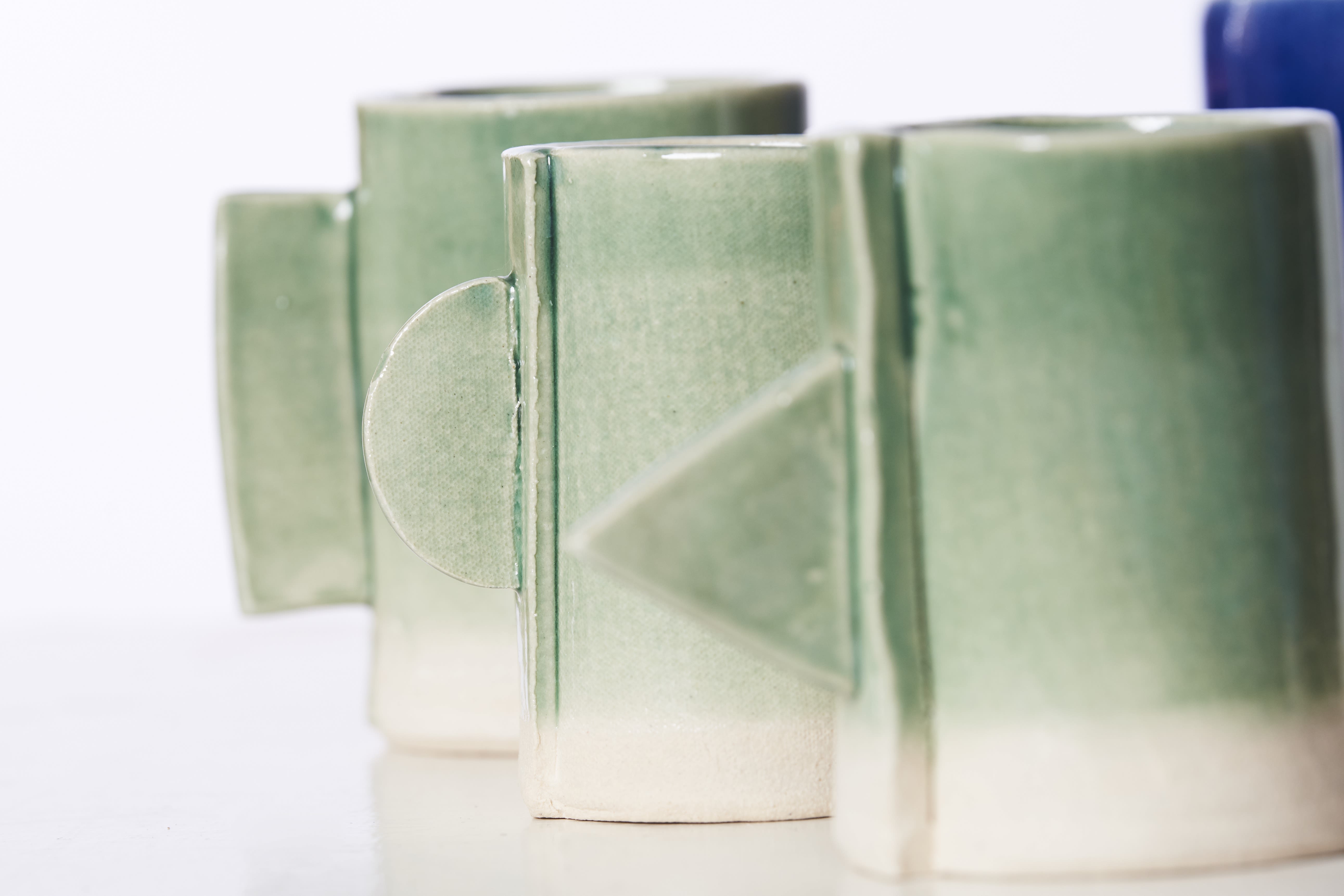 Small ceramic jugs, green in colour.