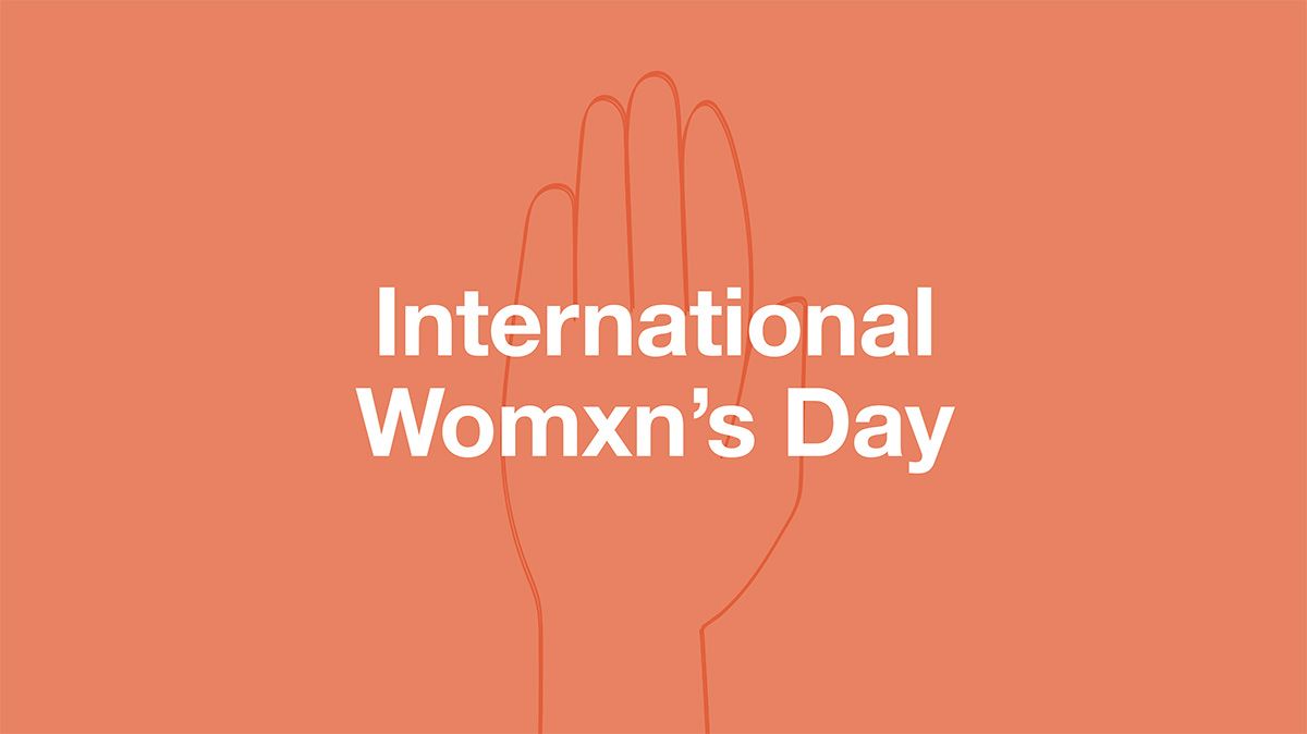 A peach-coloured banner which reads: 'International womxn's day'.