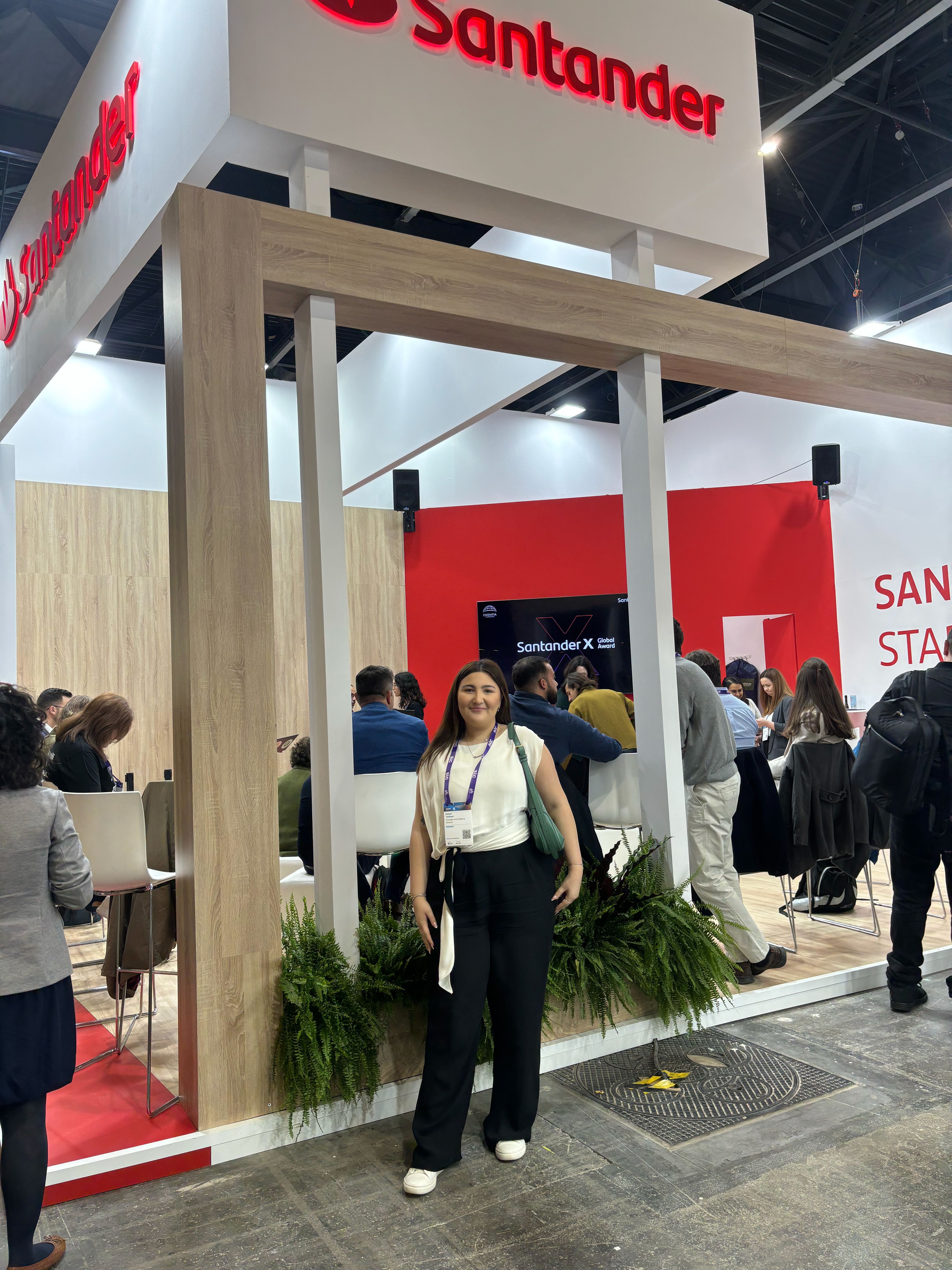 Hanan Tantush standing in front of the Santander pitching booth. 