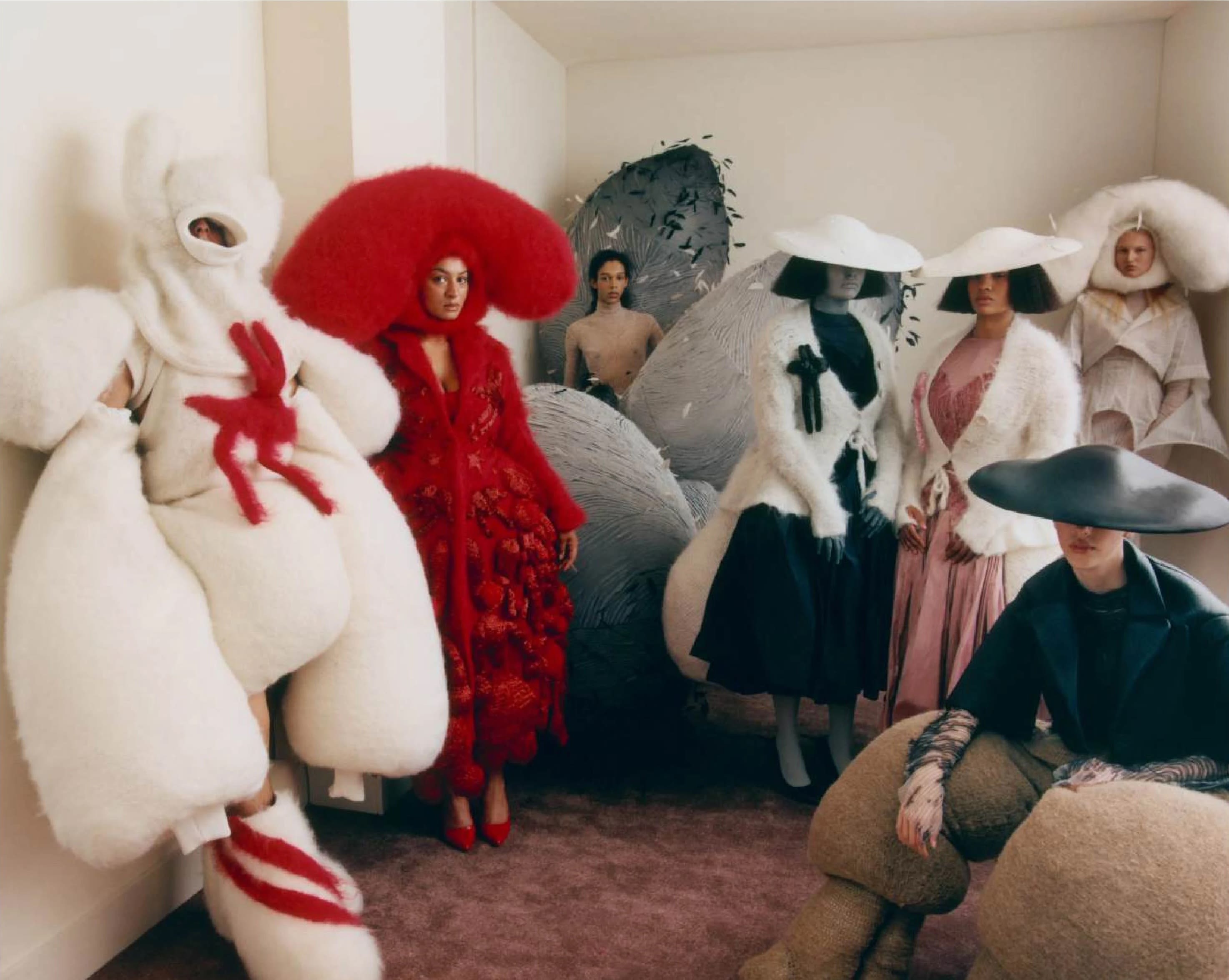 Group of people wearing large garments made in white, greys and reds