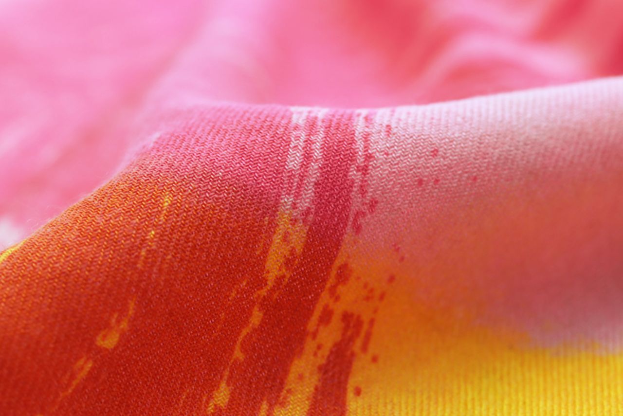 A fabric folded with pink and red shades