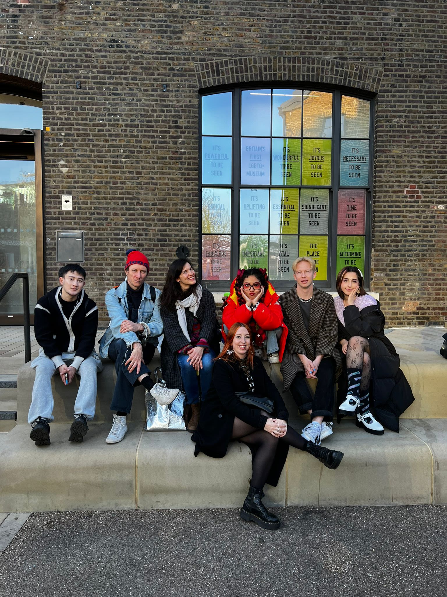 a group of students in front of a brick building