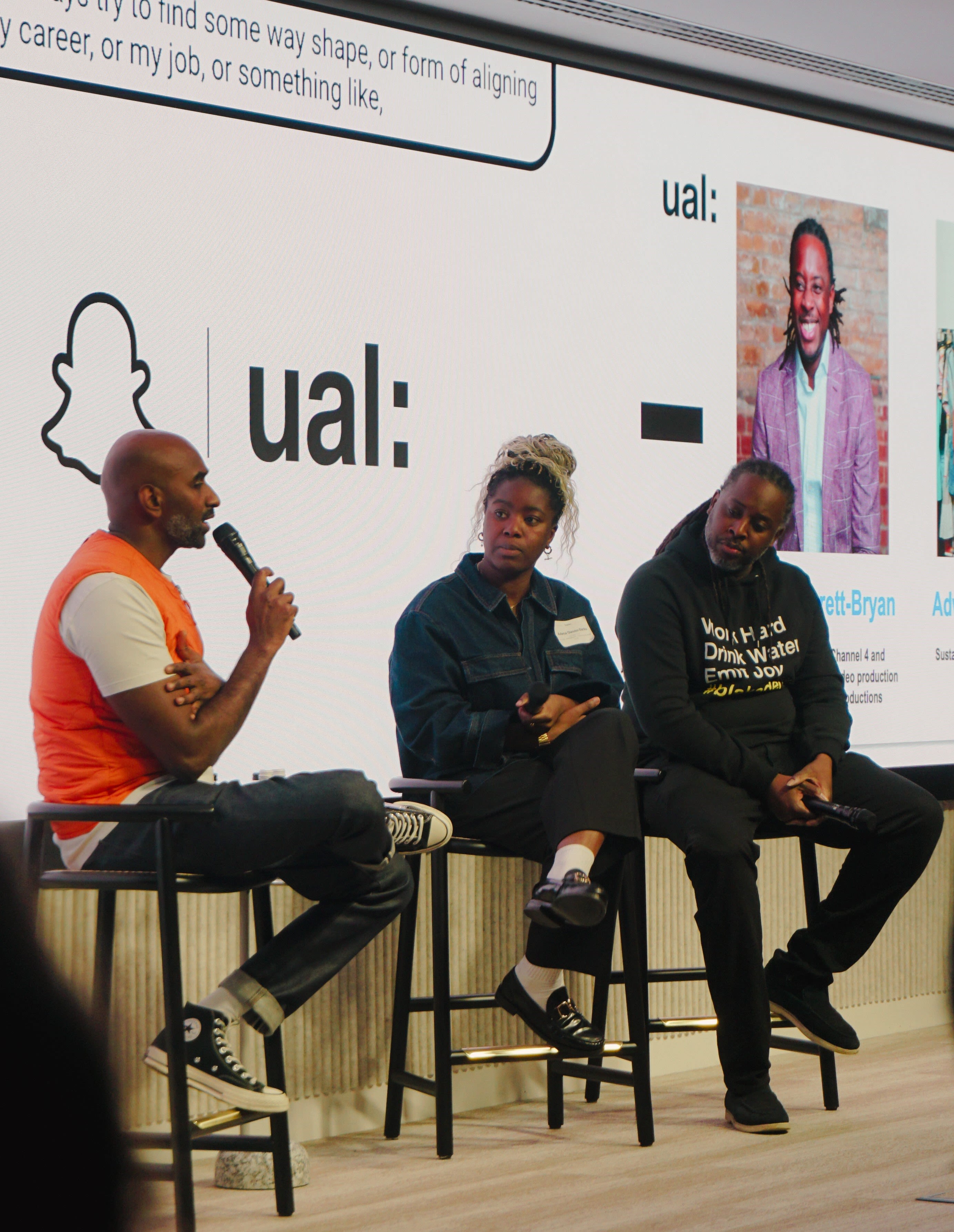Two people on stage hosting a conference