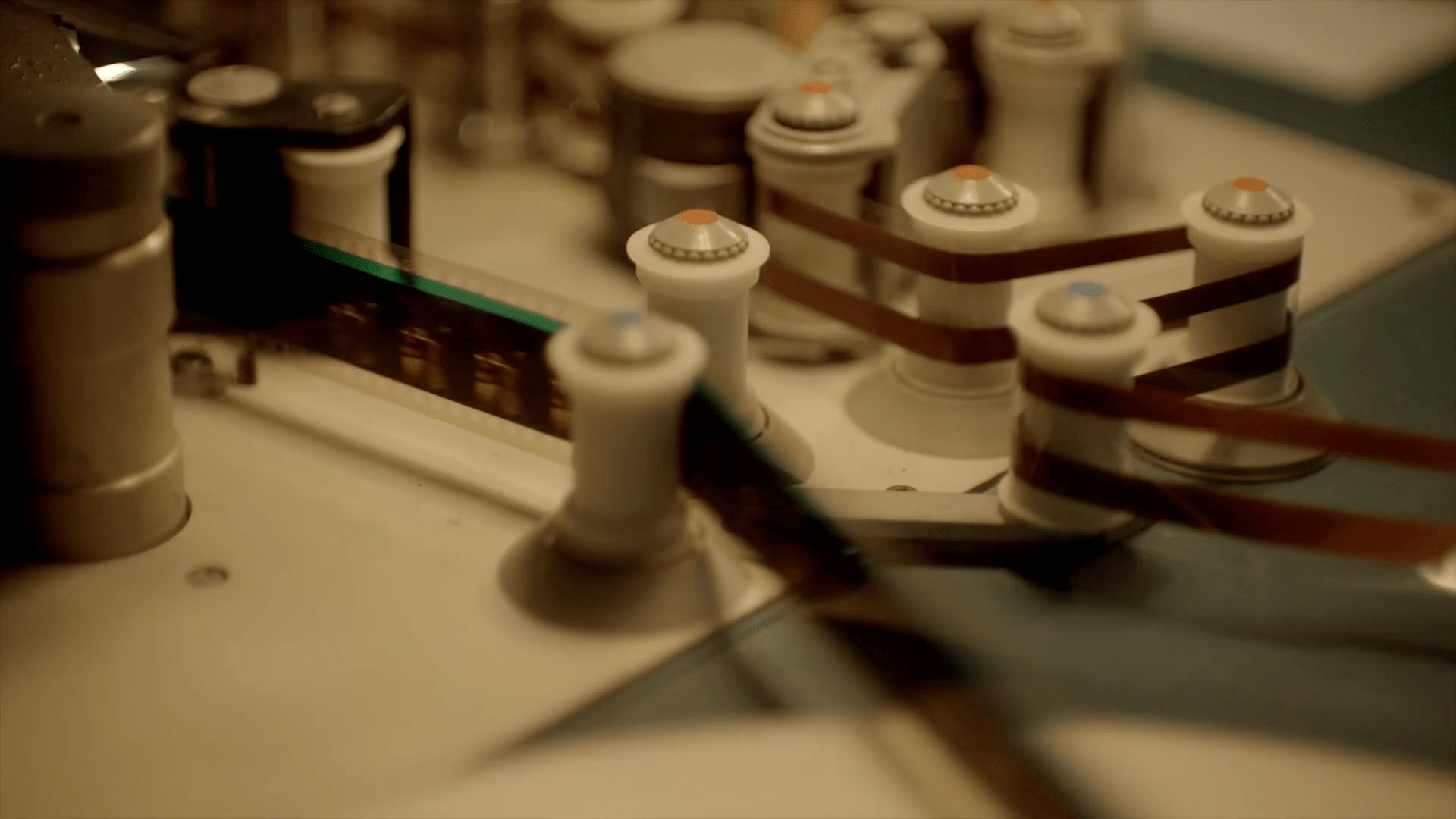 Close up of film tape passing through a machine