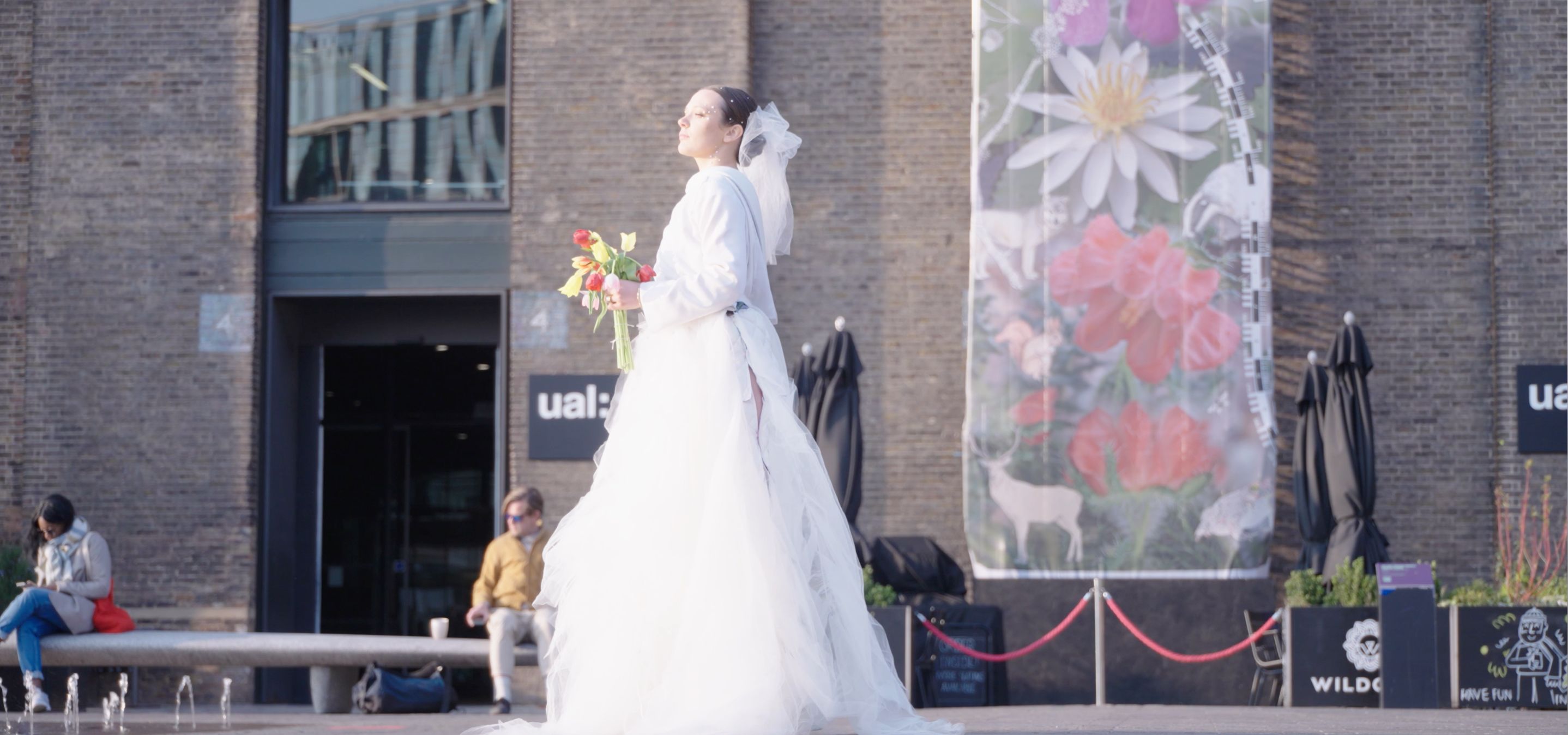 Person in bridal dress outside UAL building