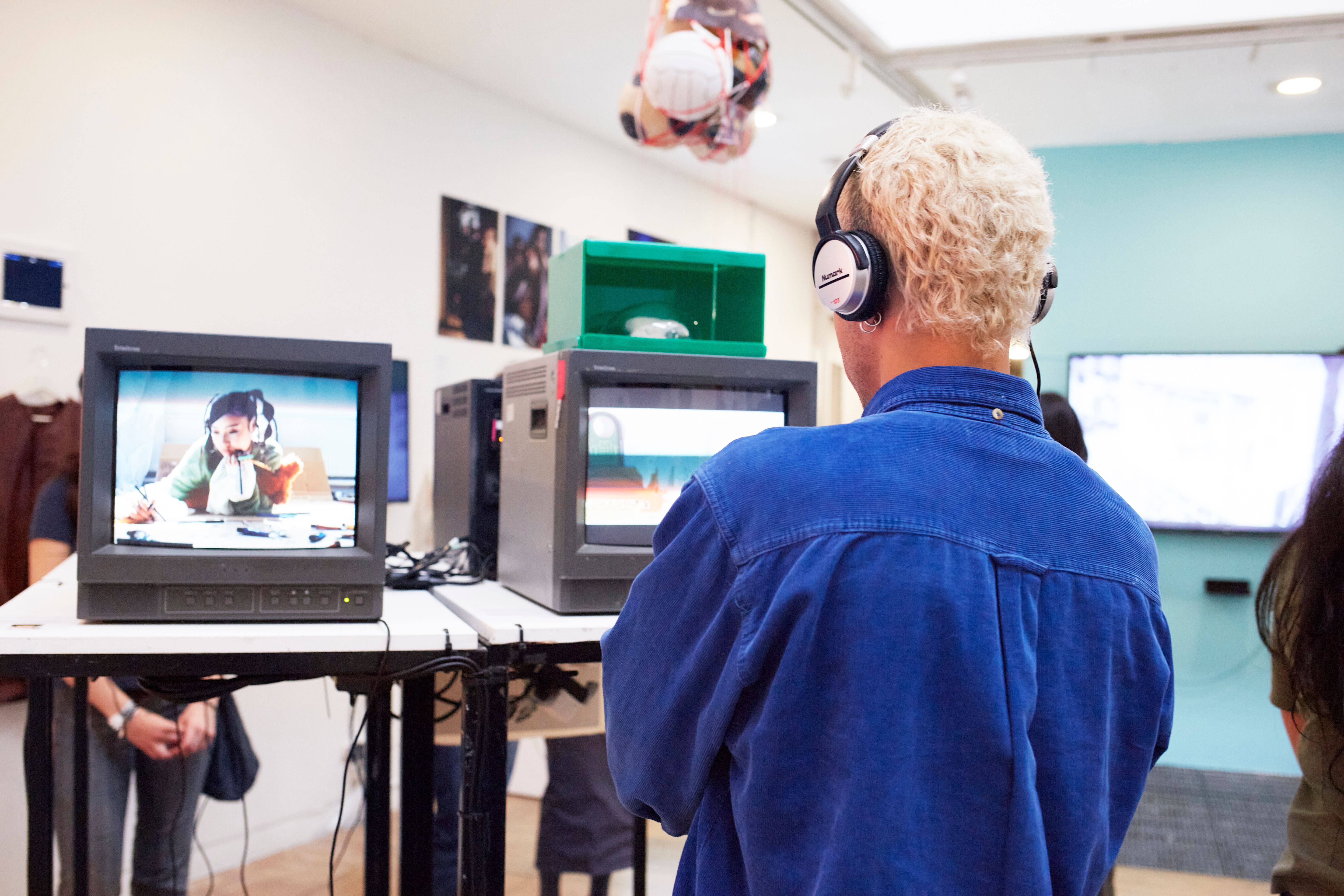 Student watching a film on a TV with headphones