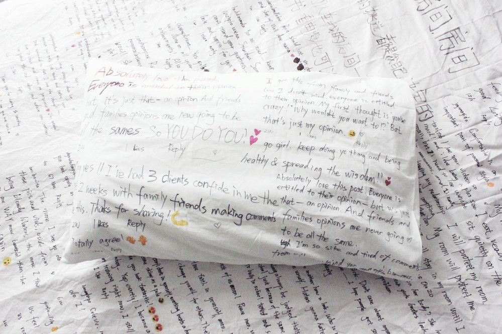 White pillow with lots of writing on it
